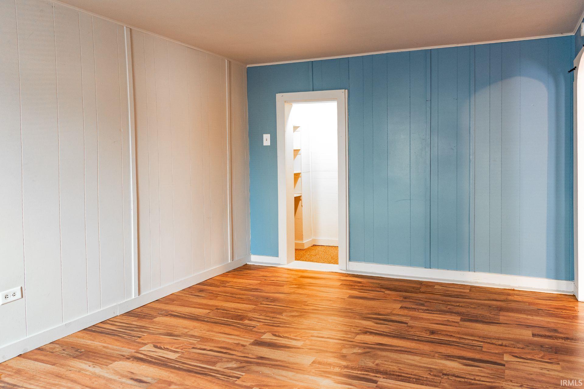 Spare room with wood finished floors and baseboards