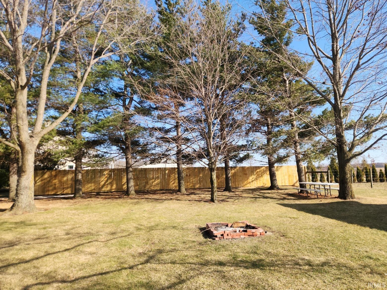 Fenced yard with an outdoor fire pit