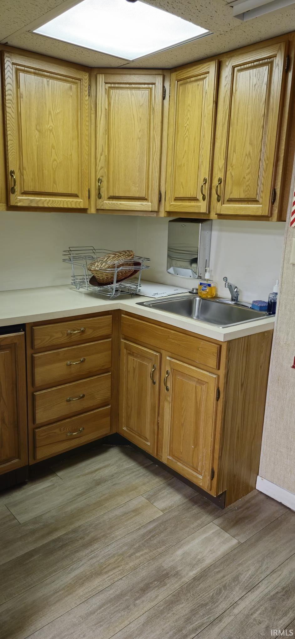Kitchen with light countertops and wood finish cabinetry