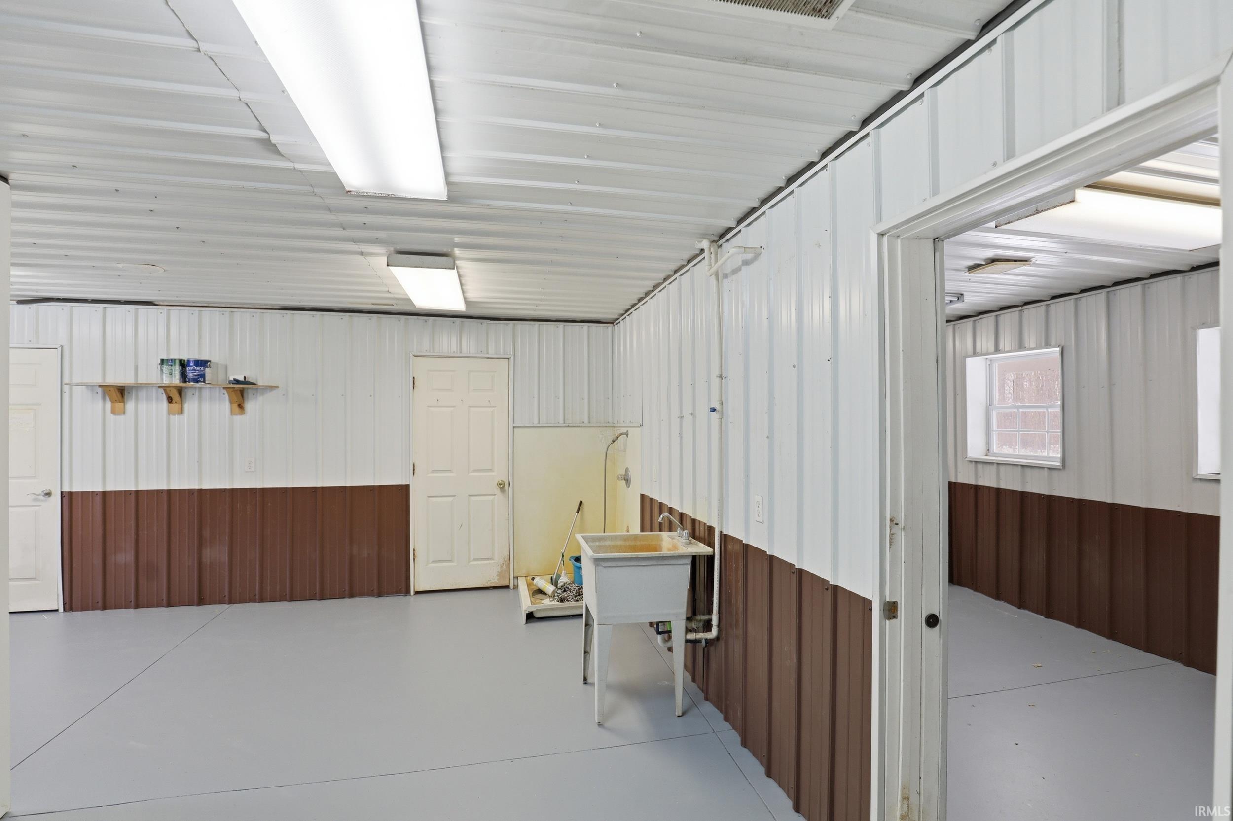 Garage with metal wall and a sink