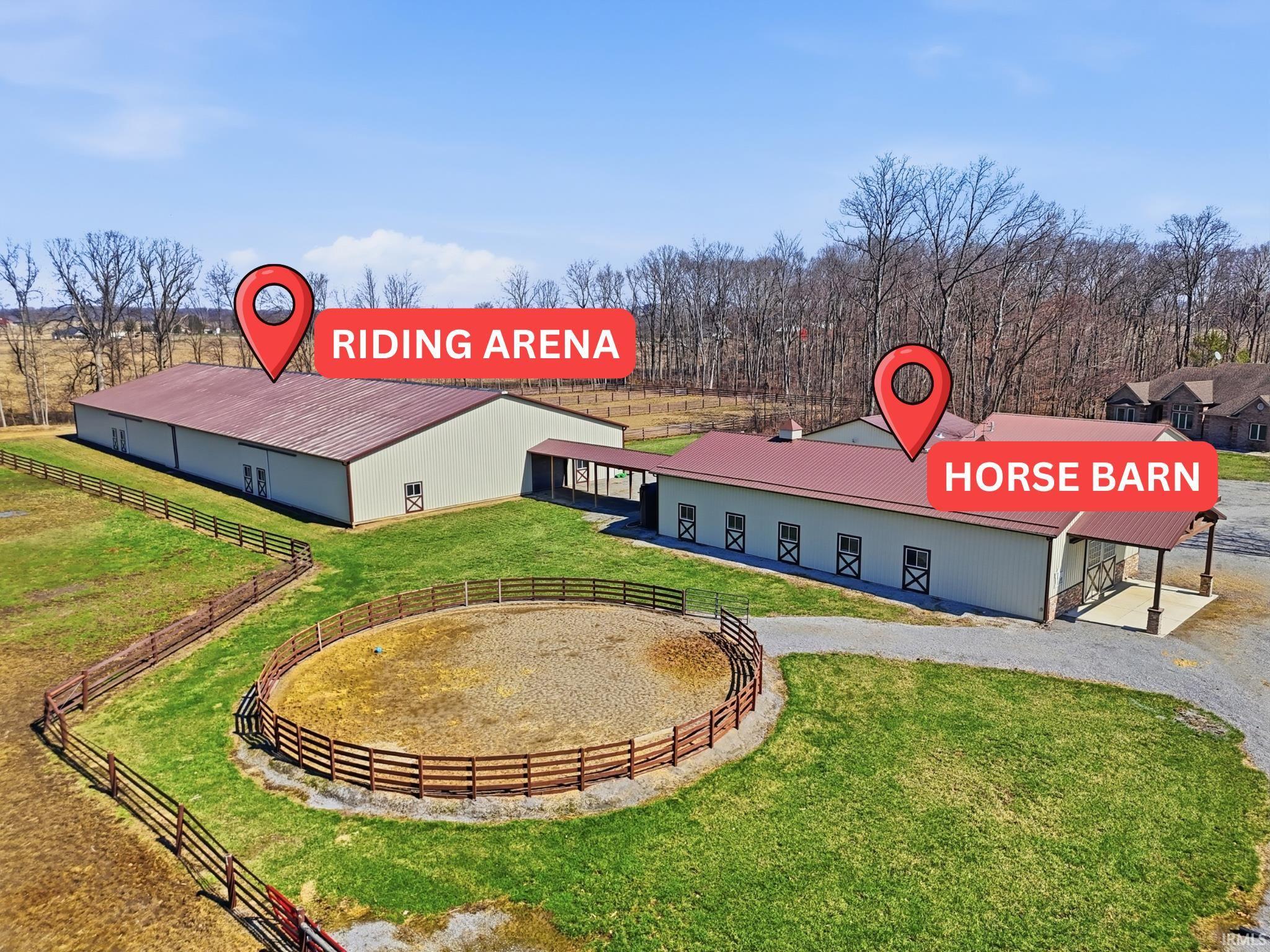 View of building exterior featuring an enclosed riding area