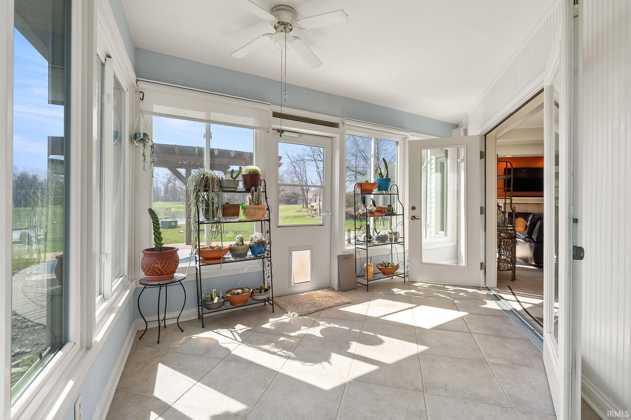 Sunroom featuring a ceiling fan