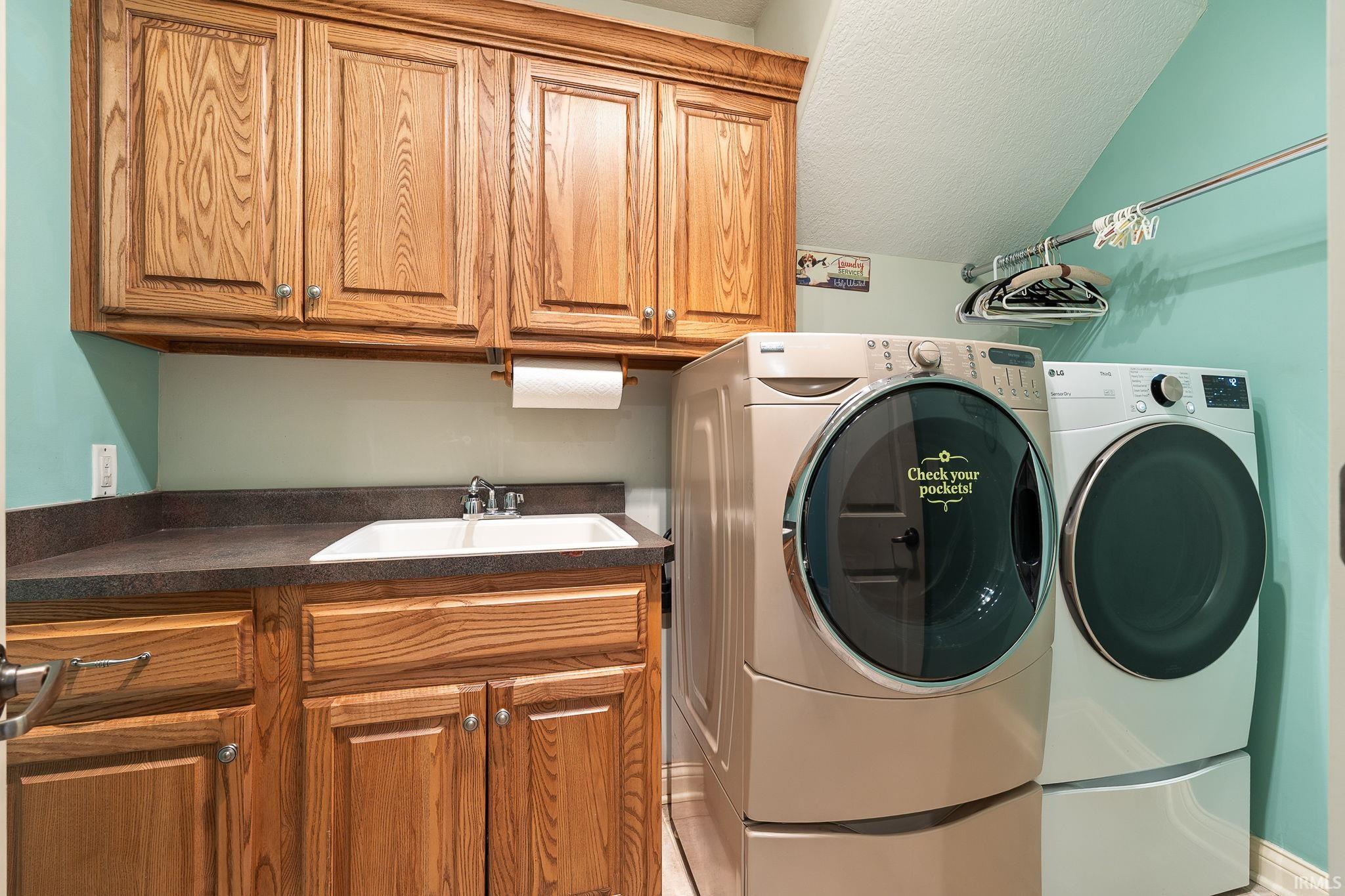 Laundry room with washing machine and dryer and cabinet space