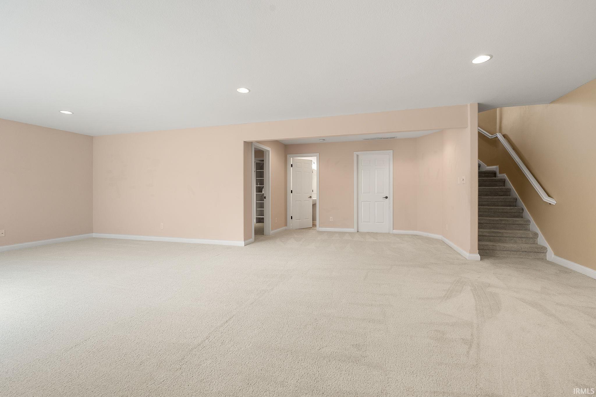 Finished basement featuring recessed lighting and light carpet