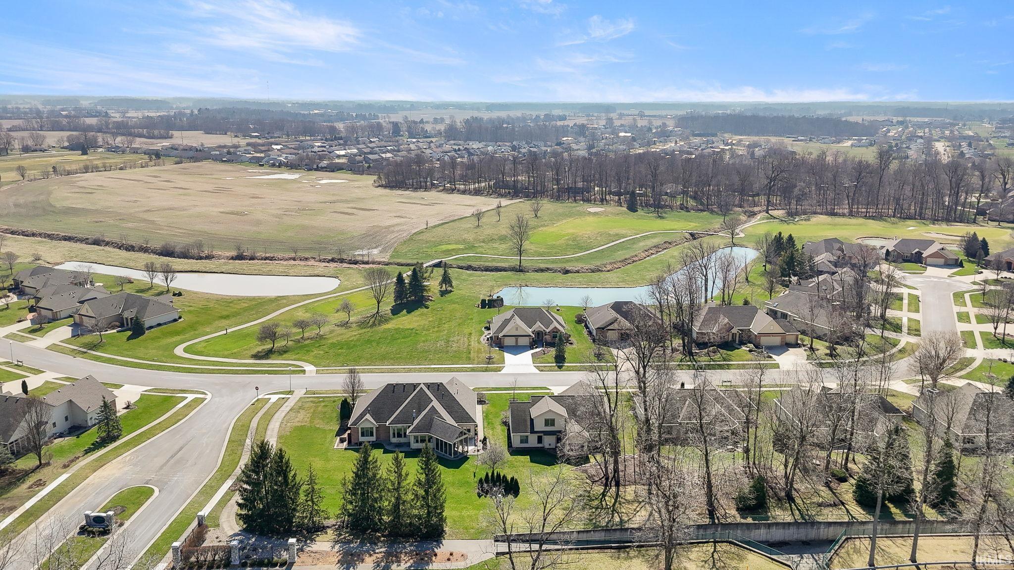 Aerial perspective of suburban area with a nearby body of water