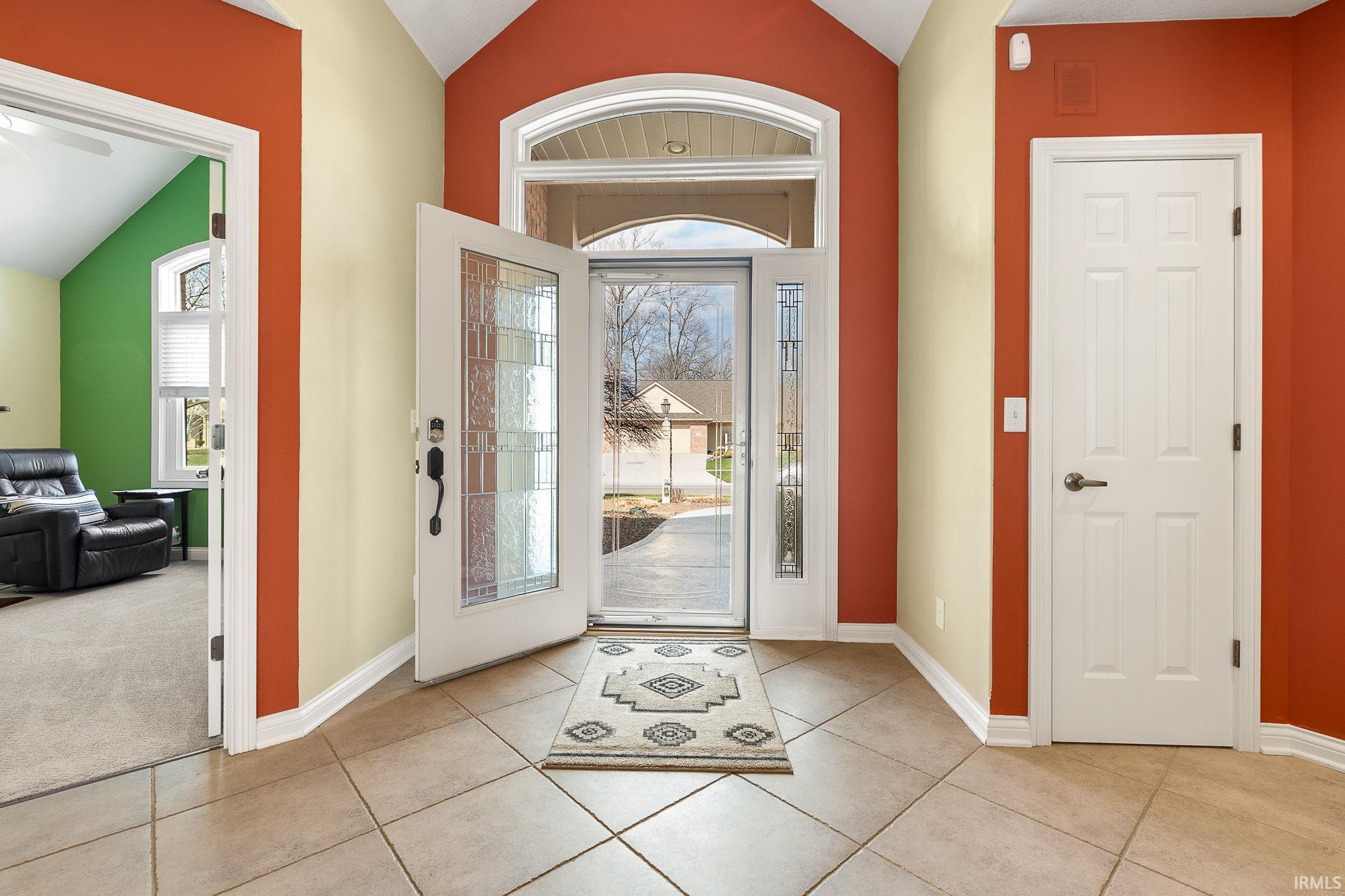 Foyer entrance featuring lofted ceiling and plenty of natural light