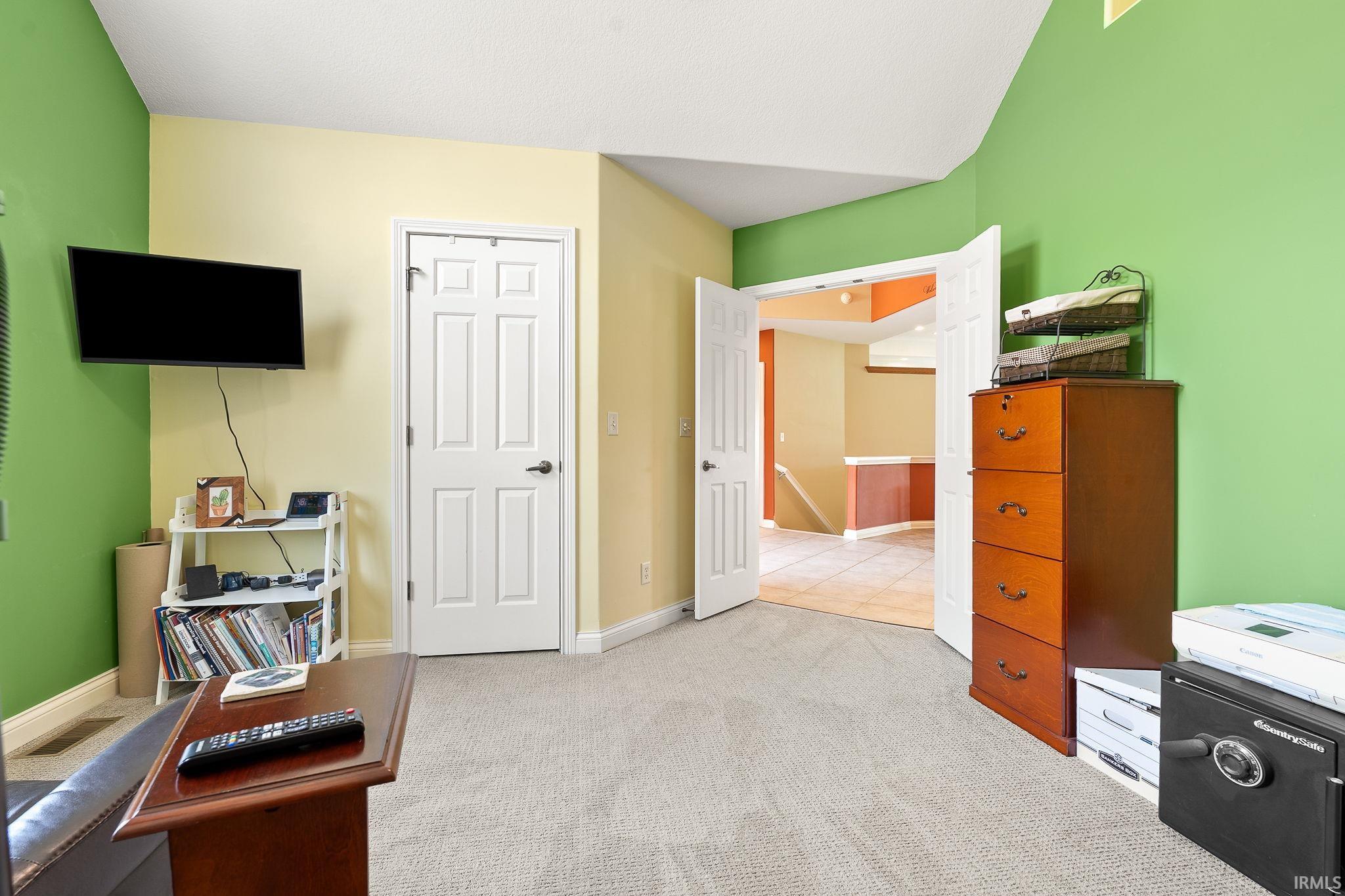 Sitting room with light carpet and baseboards