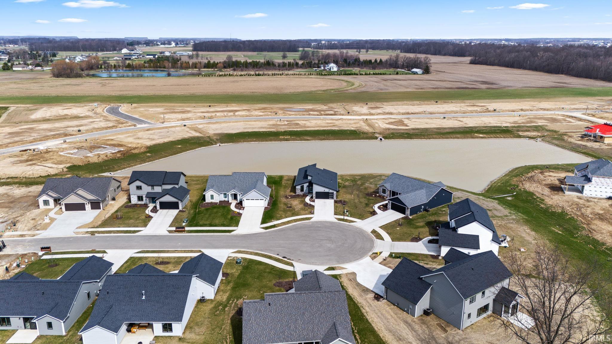 Aerial perspective of suburban area with a large body of water