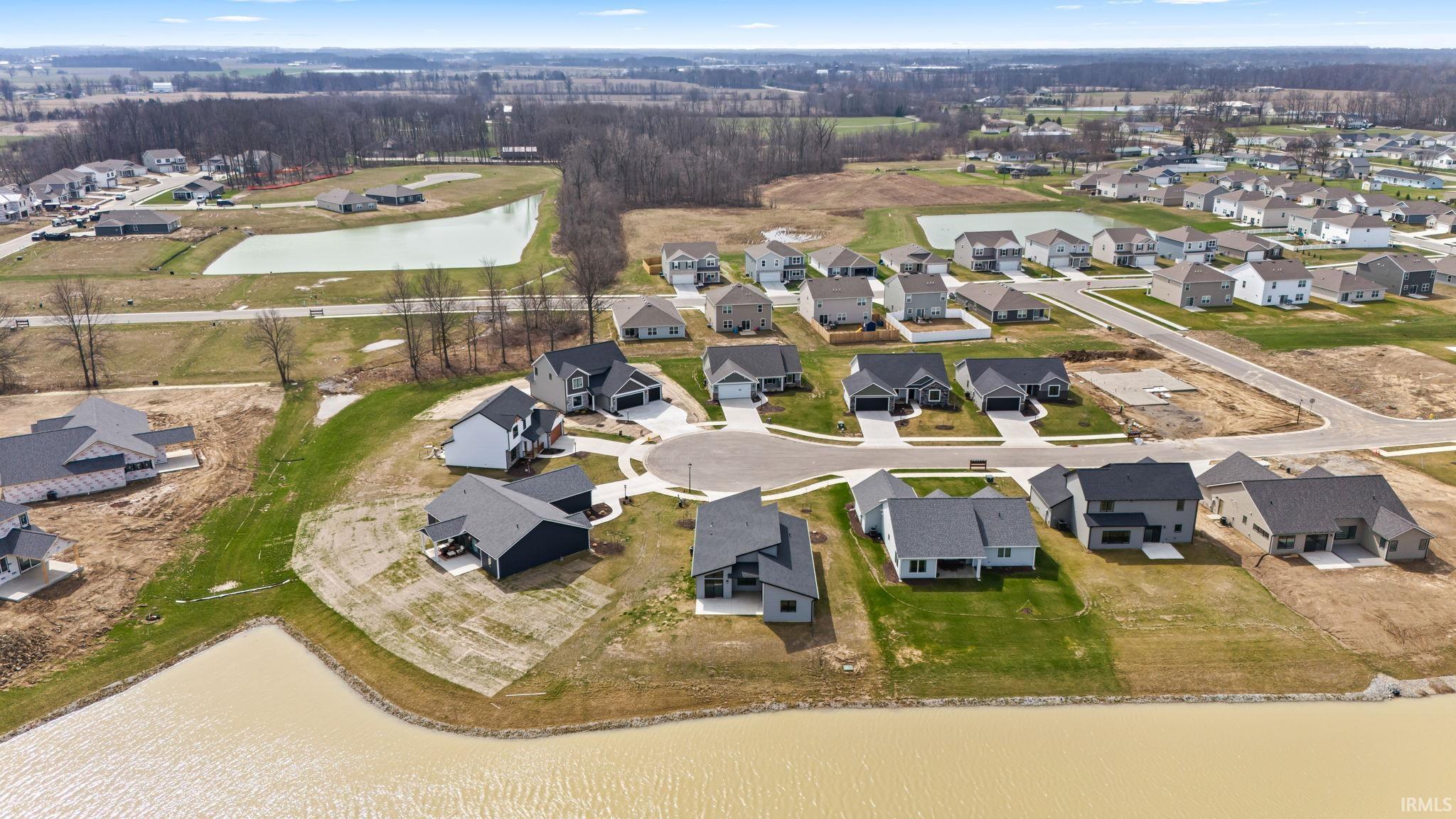 View of property location with a nearby body of water and nearby suburban area