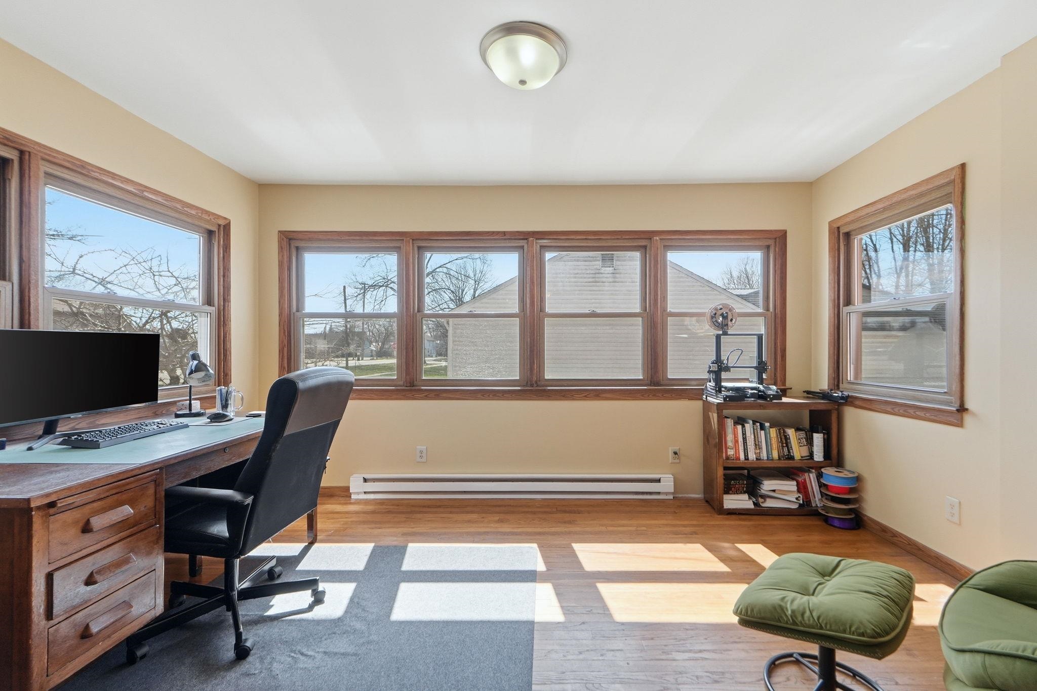 Home office with light wood-type flooring and baseboard heating