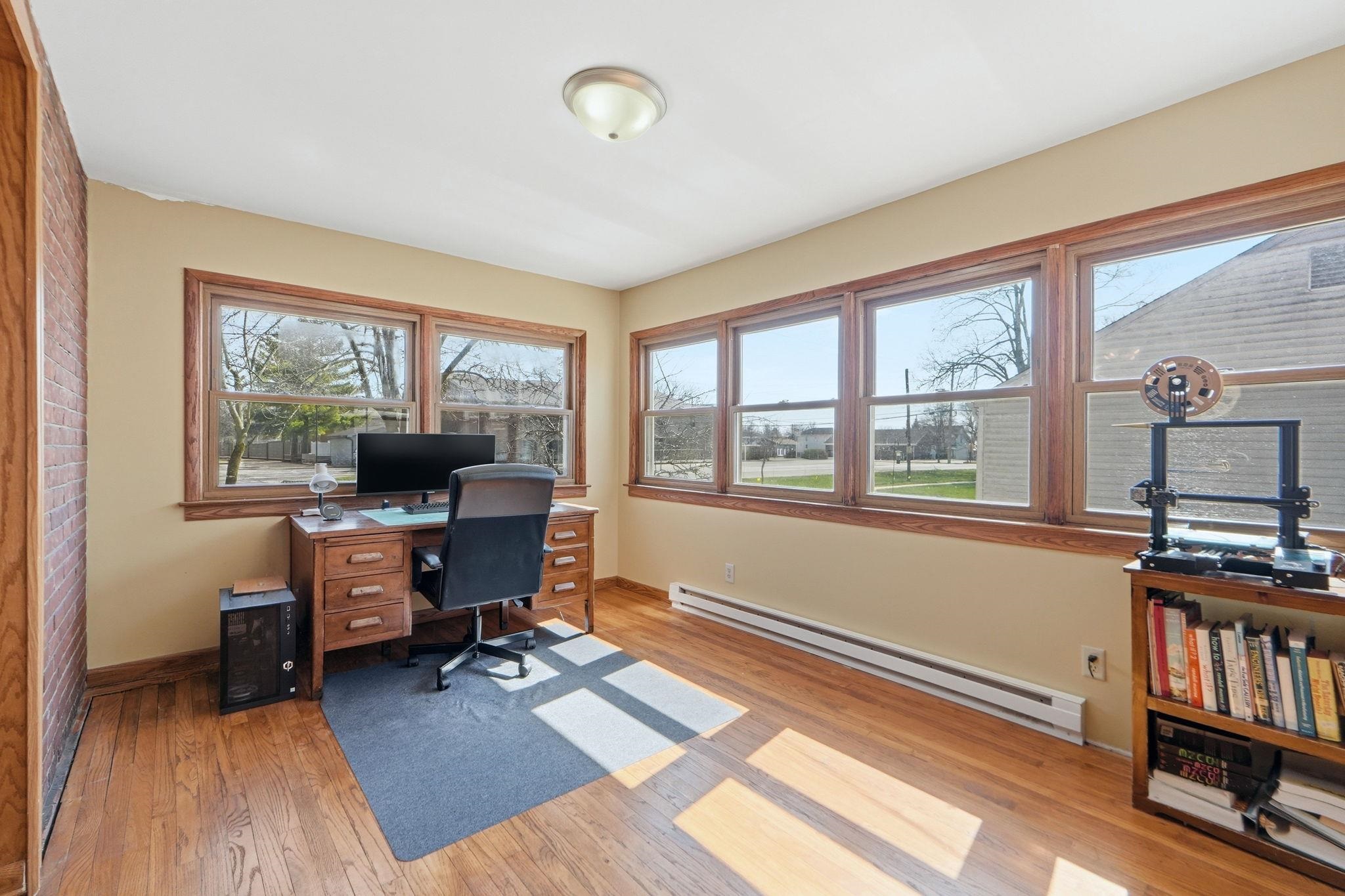 Office area with a baseboard radiator and light wood finished floors
