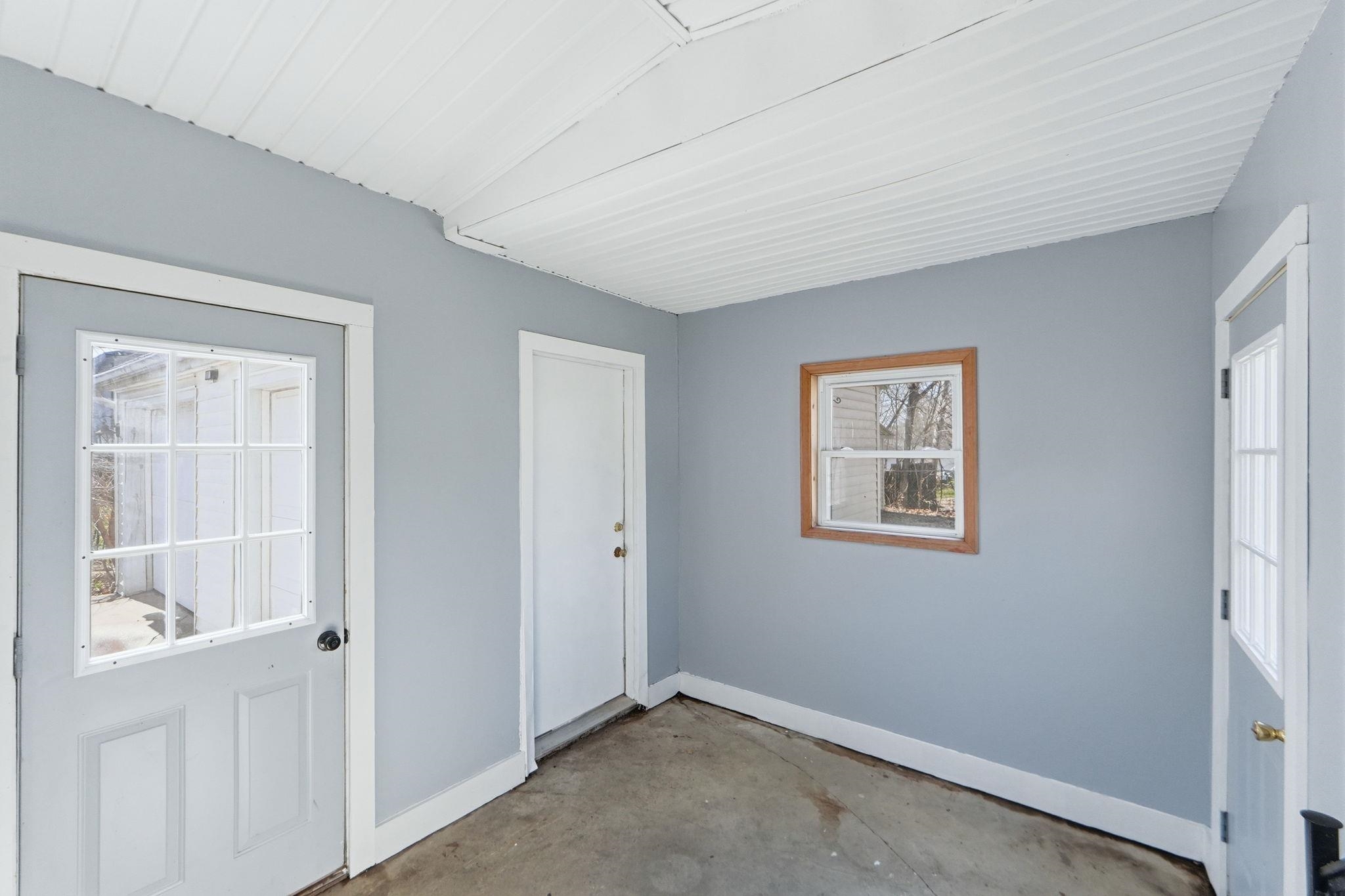 Entryway with concrete flooring and baseboards