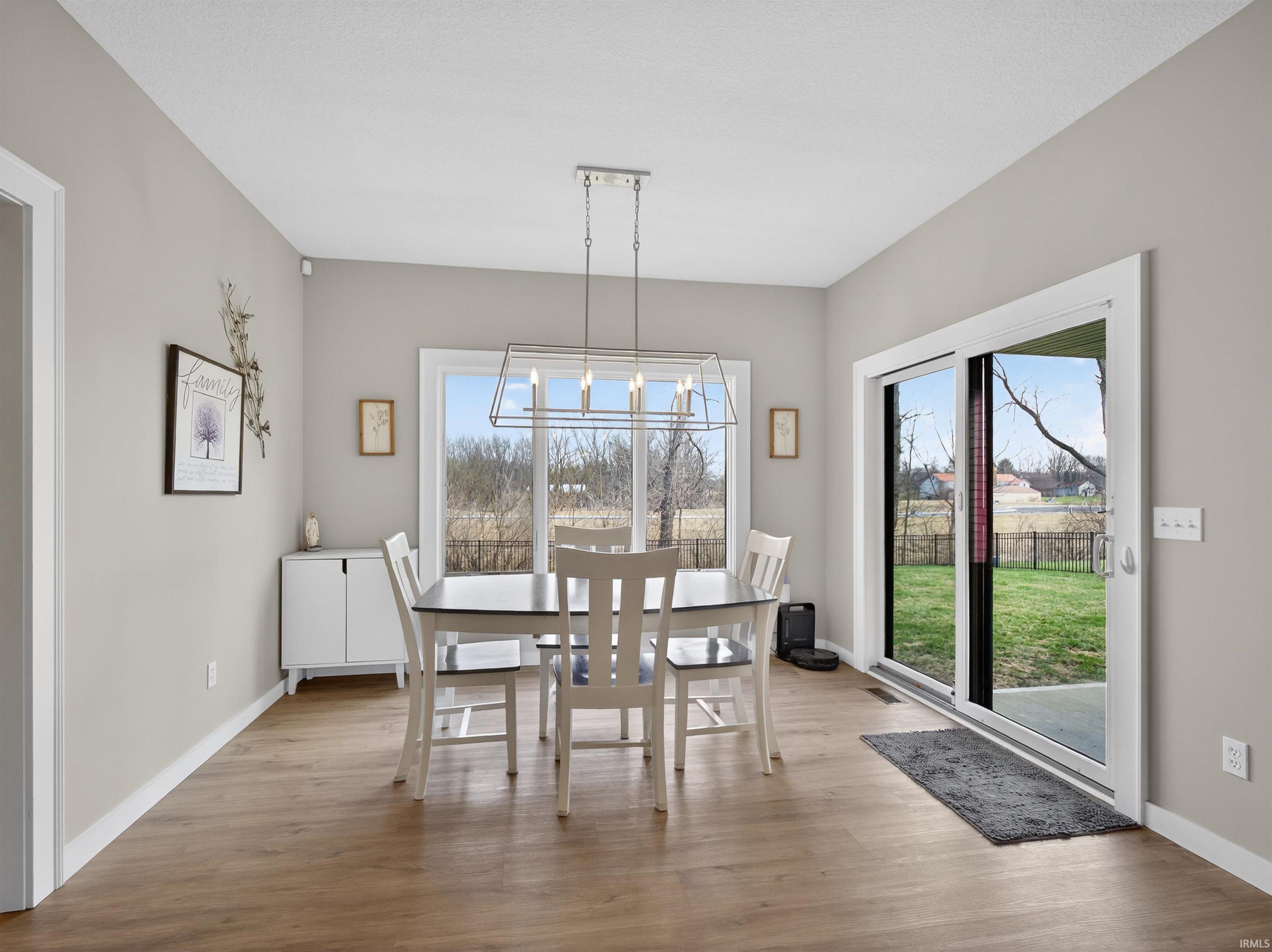 Dining room featuring light wood finished floors and hanging lights