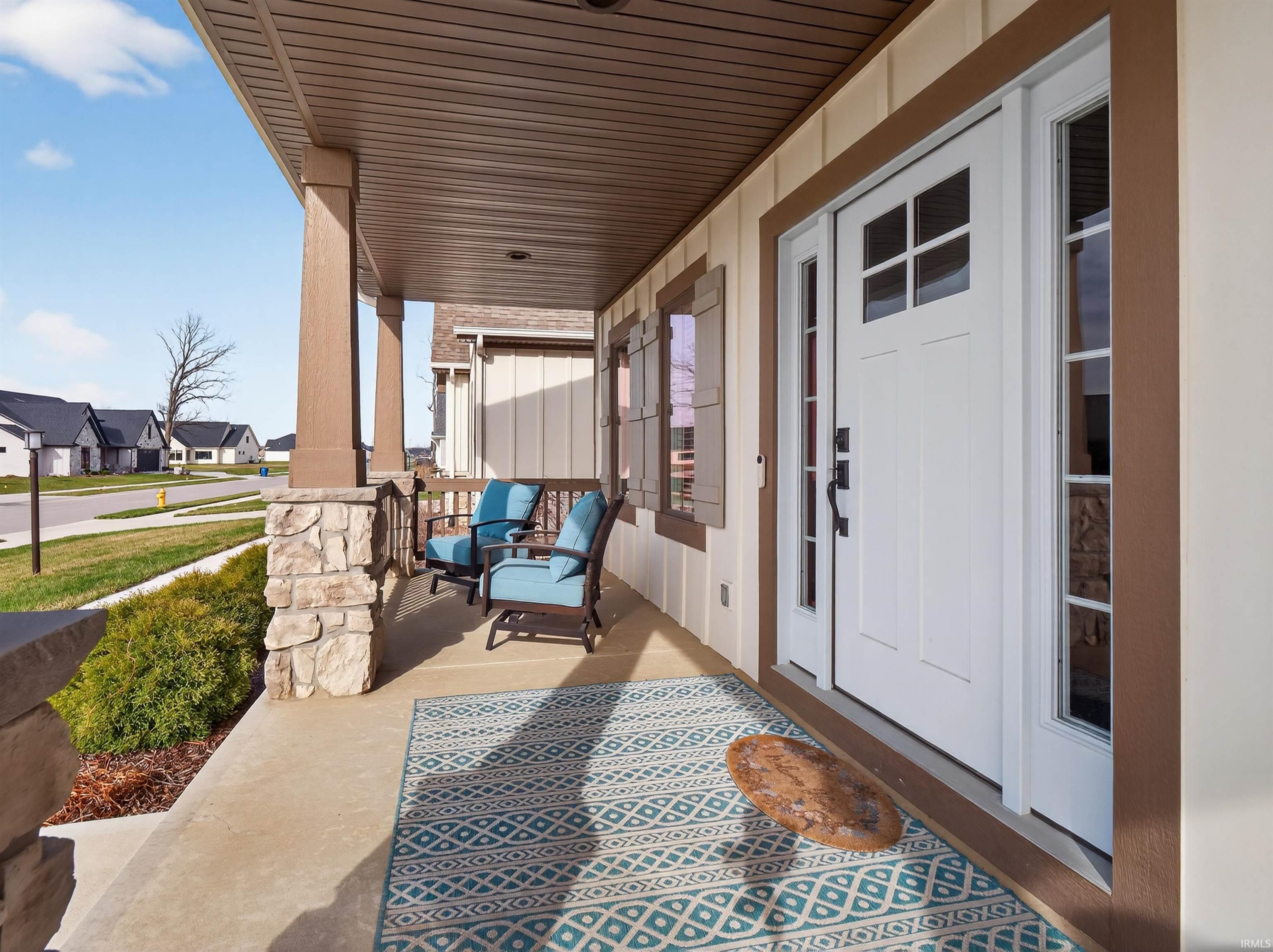 Covered porch featuring a residential view