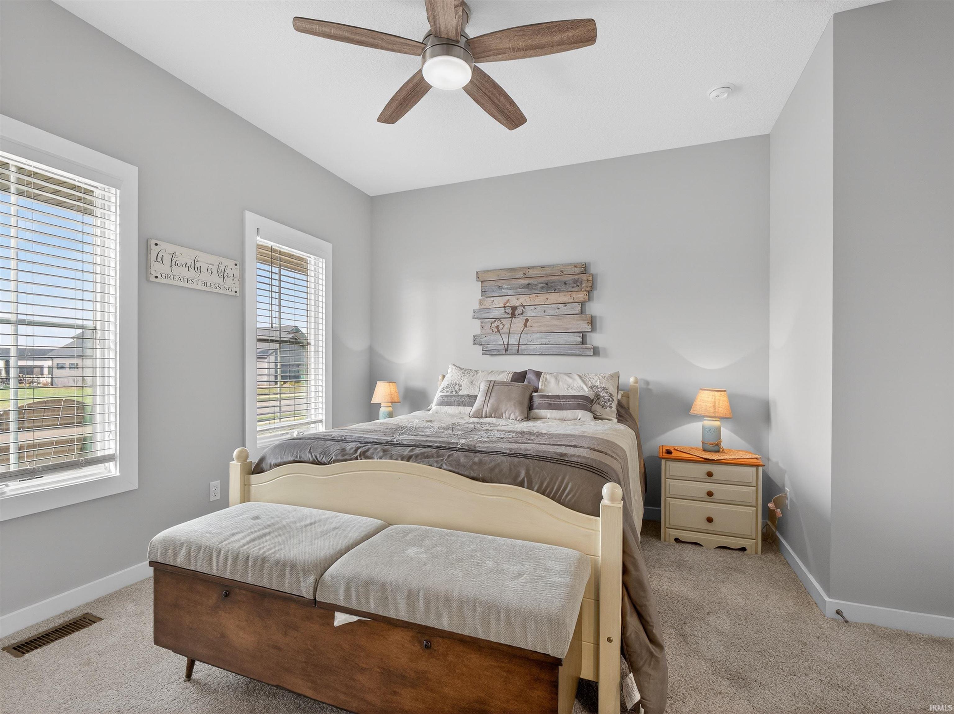 Bedroom featuring light carpet and a ceiling fan