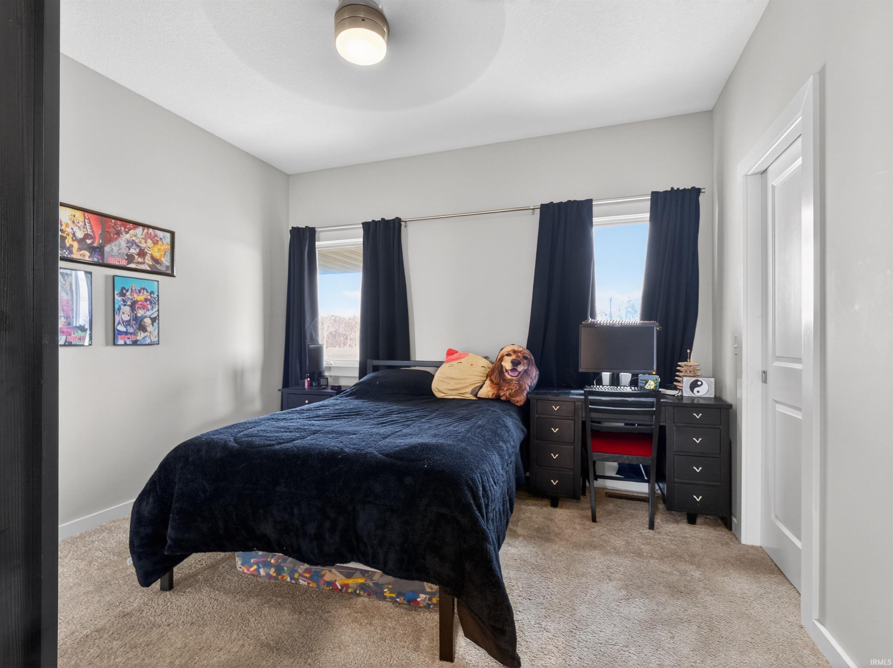 Bedroom featuring light carpet and a ceiling fan