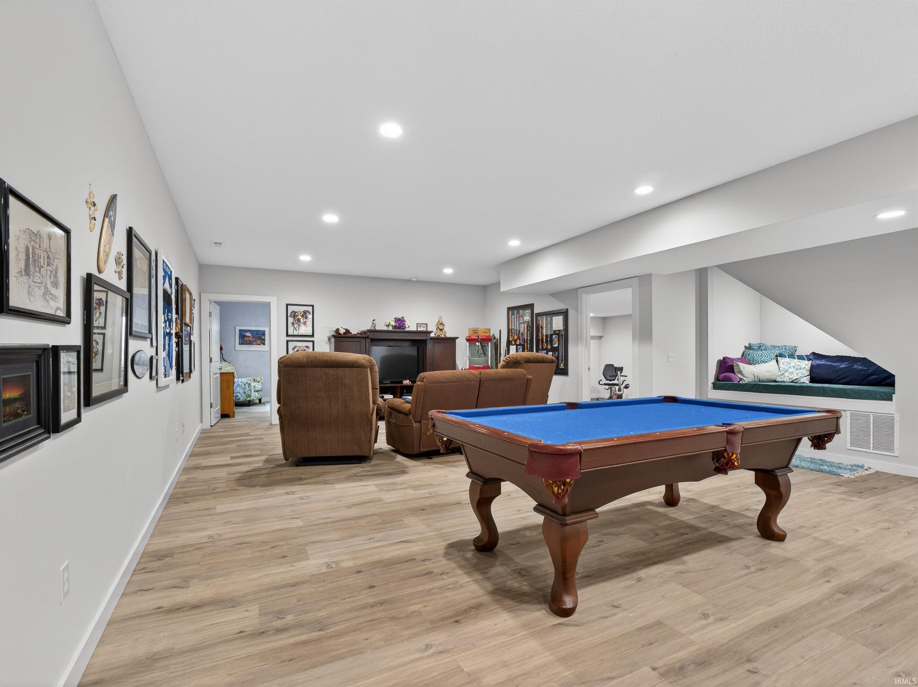 Rec room with pool table, light wood-style floors, a fireplace, and recessed lighting