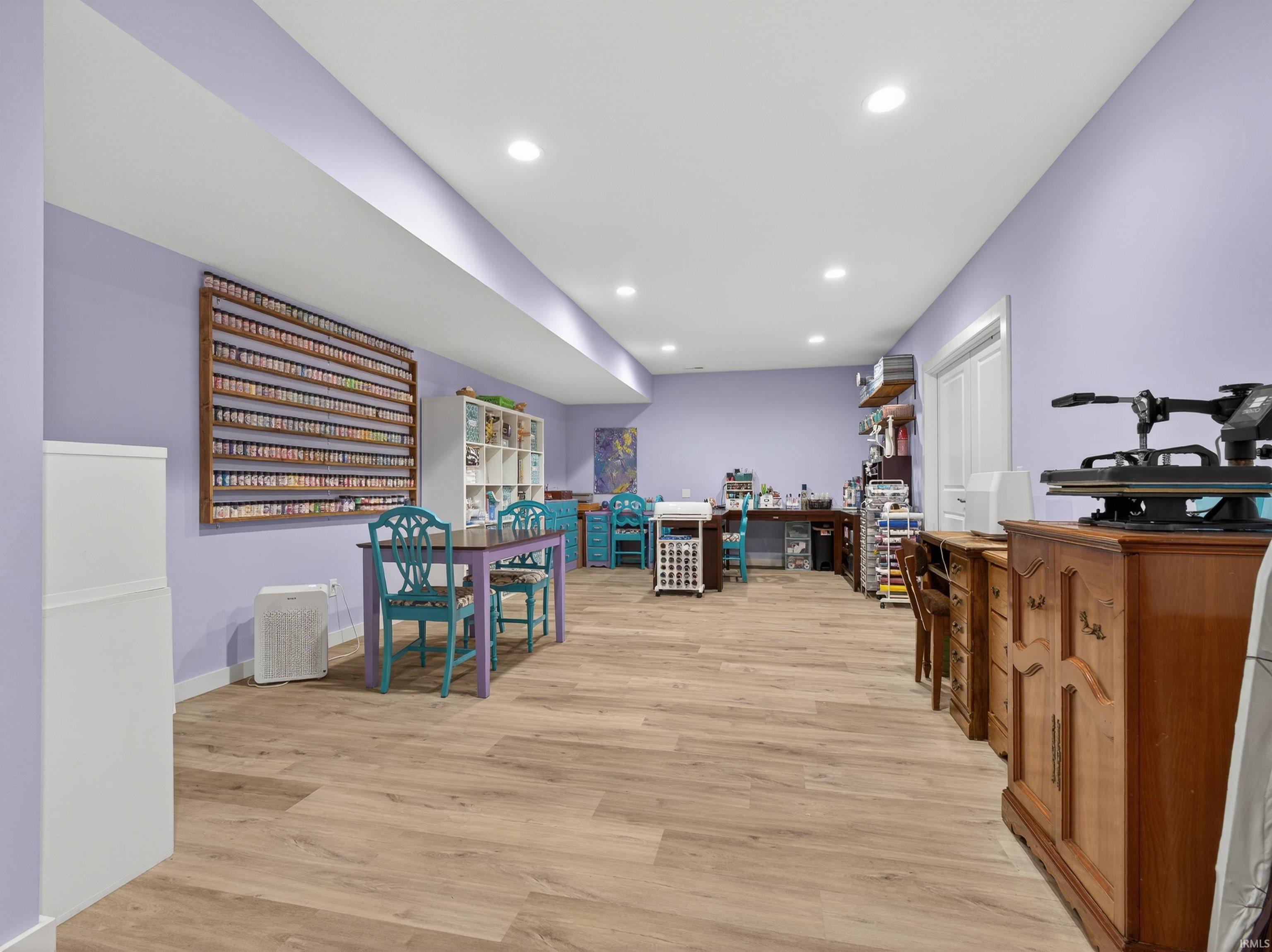 Rec room with light wood-style flooring and recessed lighting