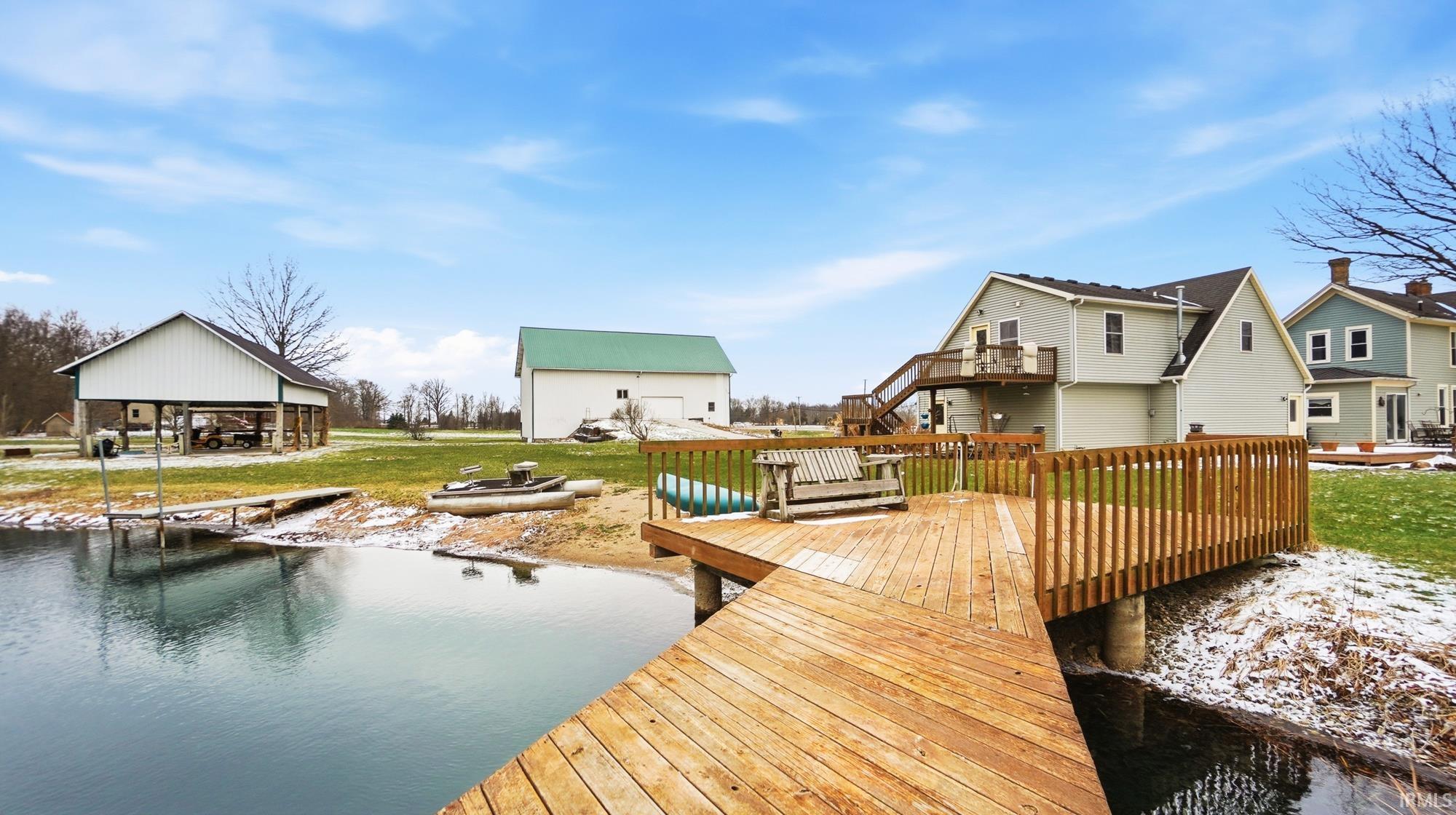 Dock area with a yard and a water view