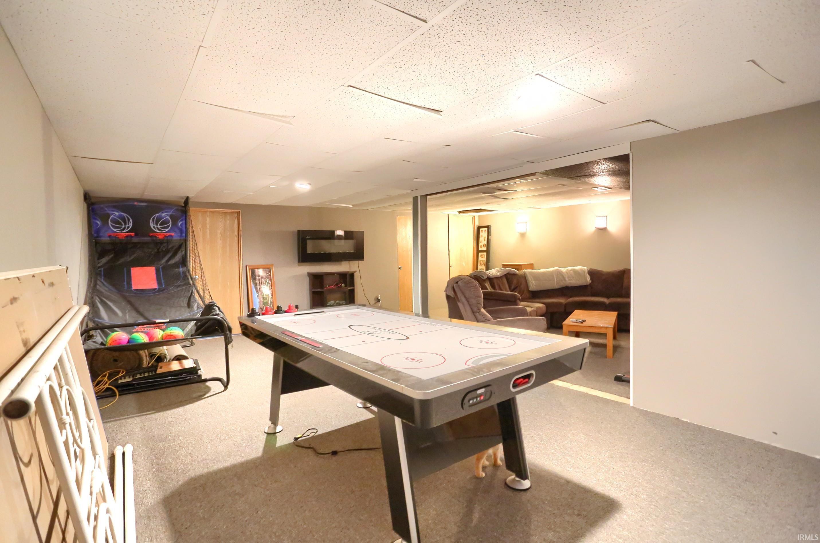 Recreation room with a paneled ceiling
