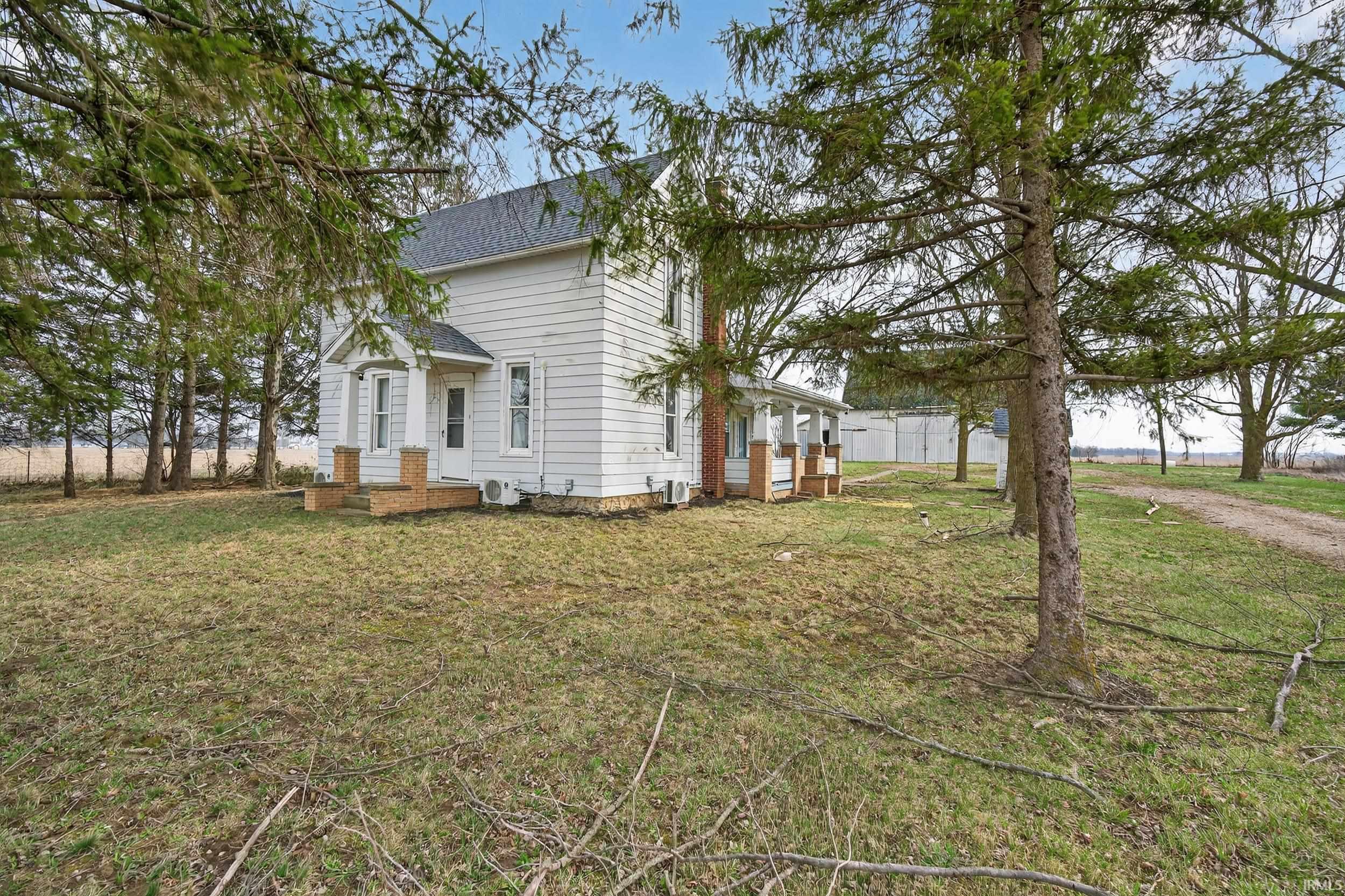 View of home's exterior with roof with shingles and a lawn