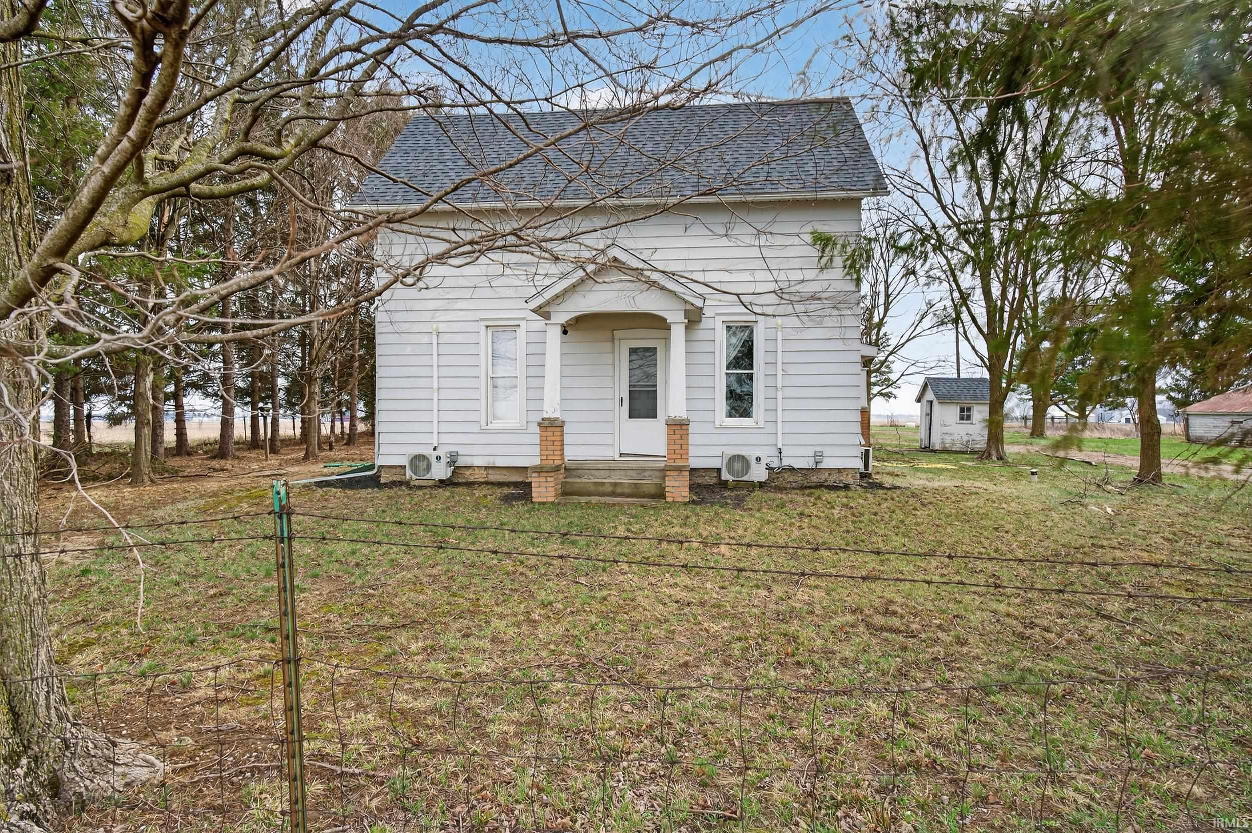 Rear view of property with a shingled roof