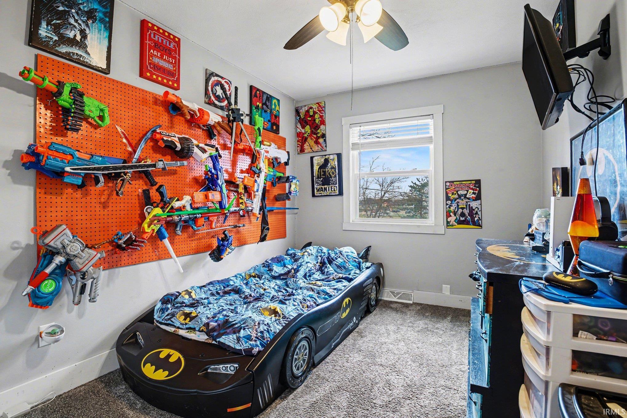 Bedroom with light colored carpet and ceiling fan
