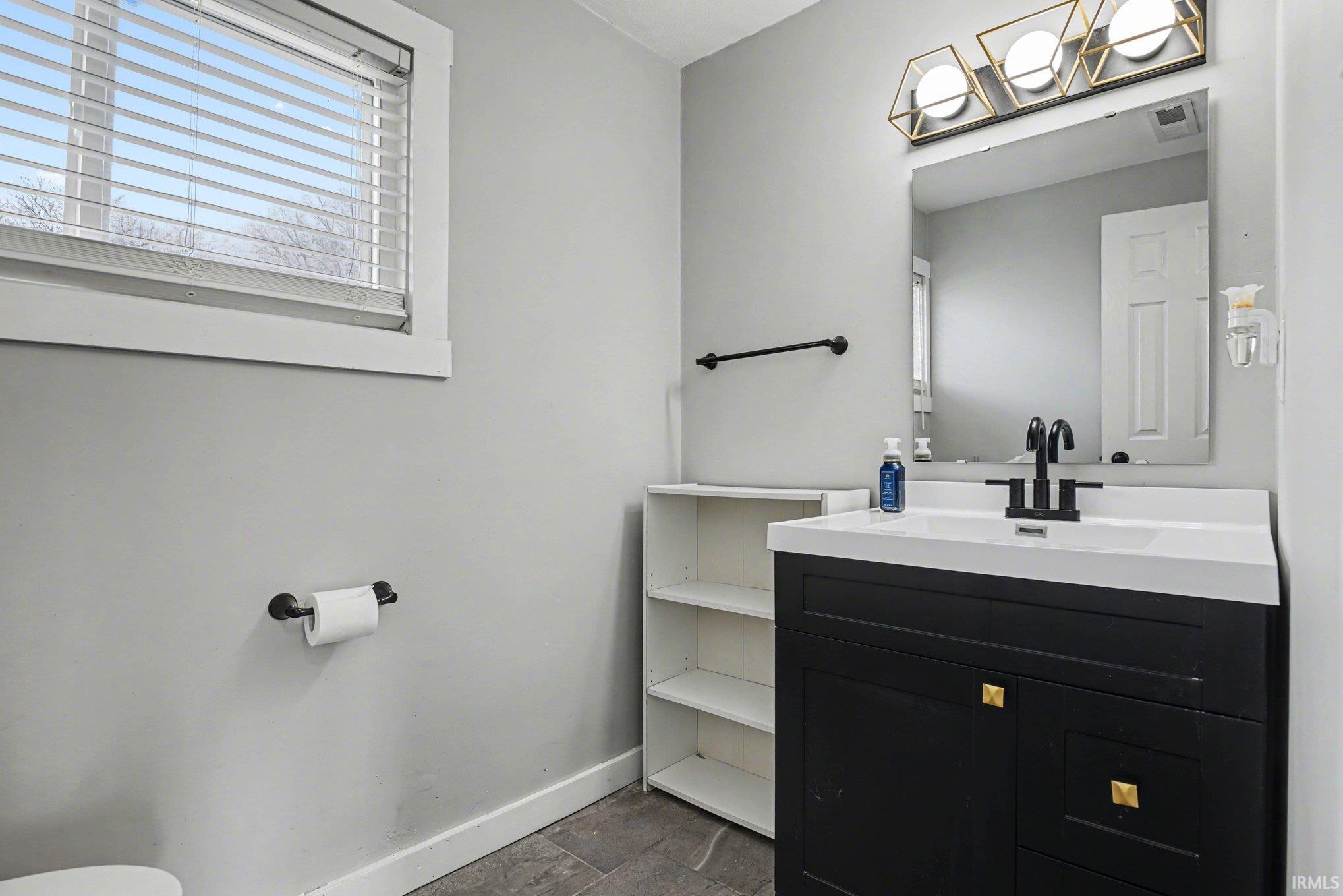 Bathroom with stone tile floors and vanity