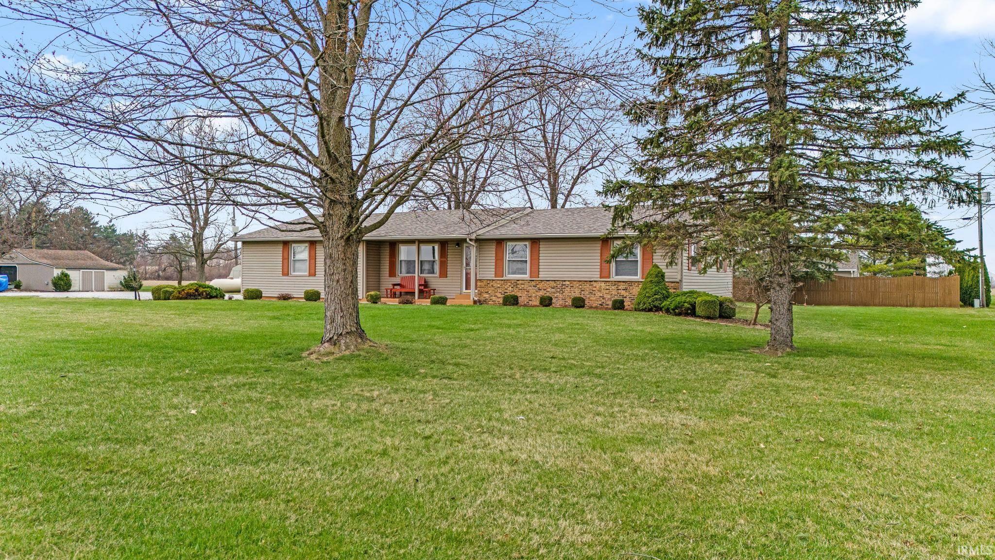 Ranch-style house with a shingled roof