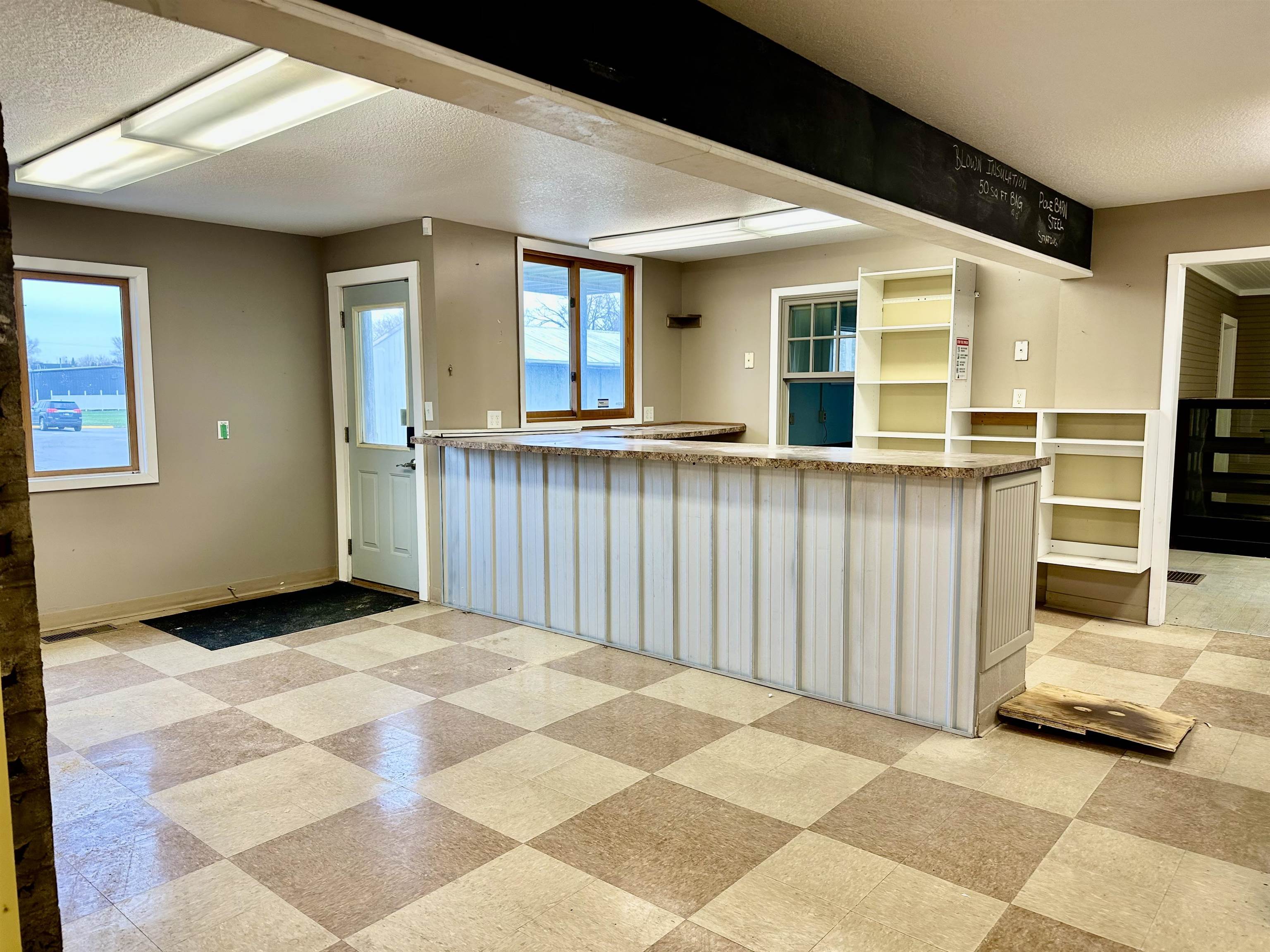 Kitchen featuring a textured ceiling, light countertops, and a peninsula