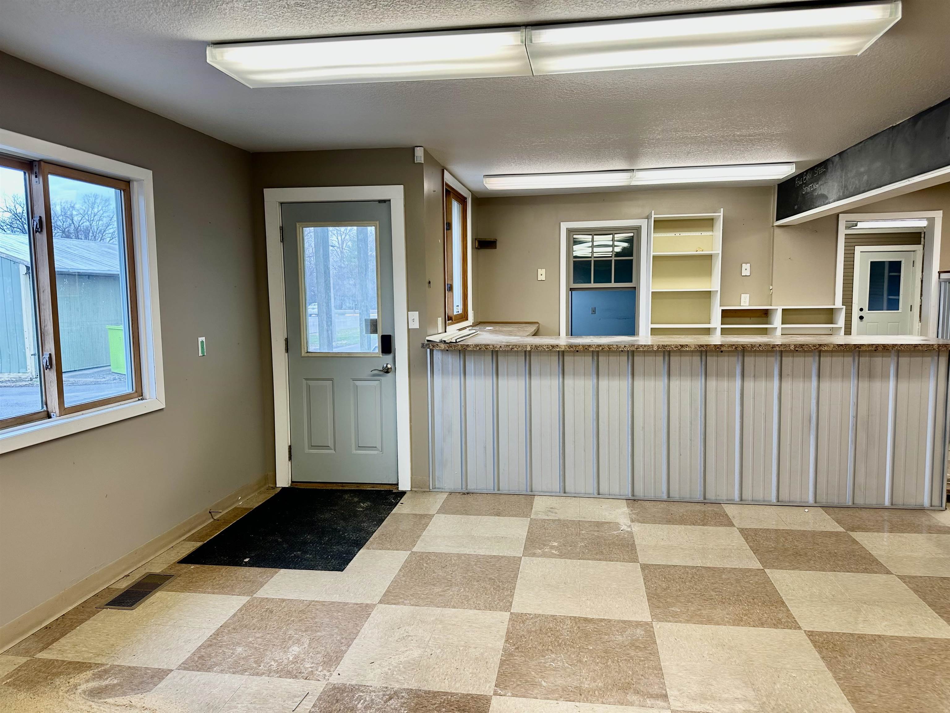 Entryway featuring light flooring and a textured ceiling