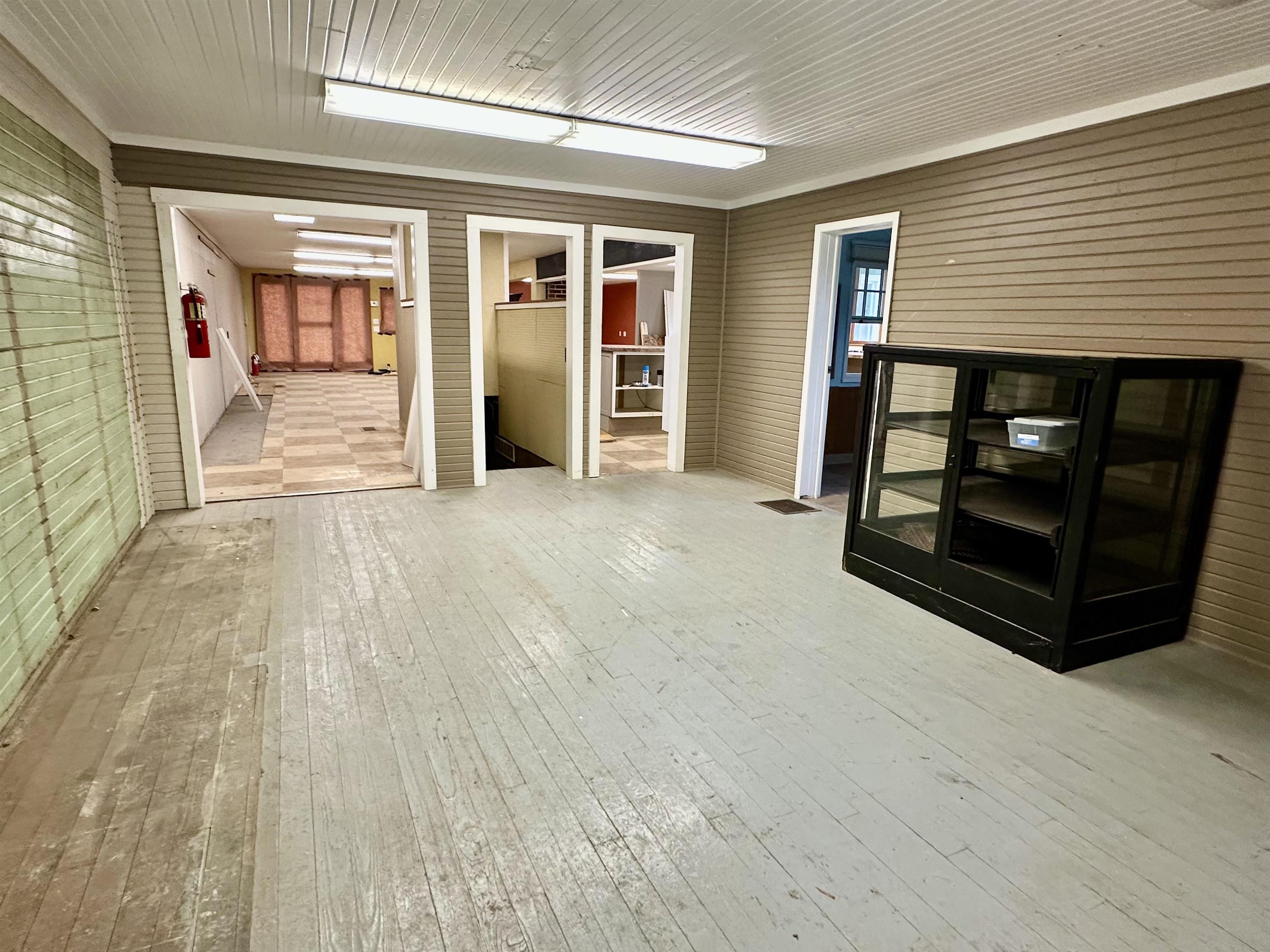 Spare room with light wood-style flooring and wooden walls