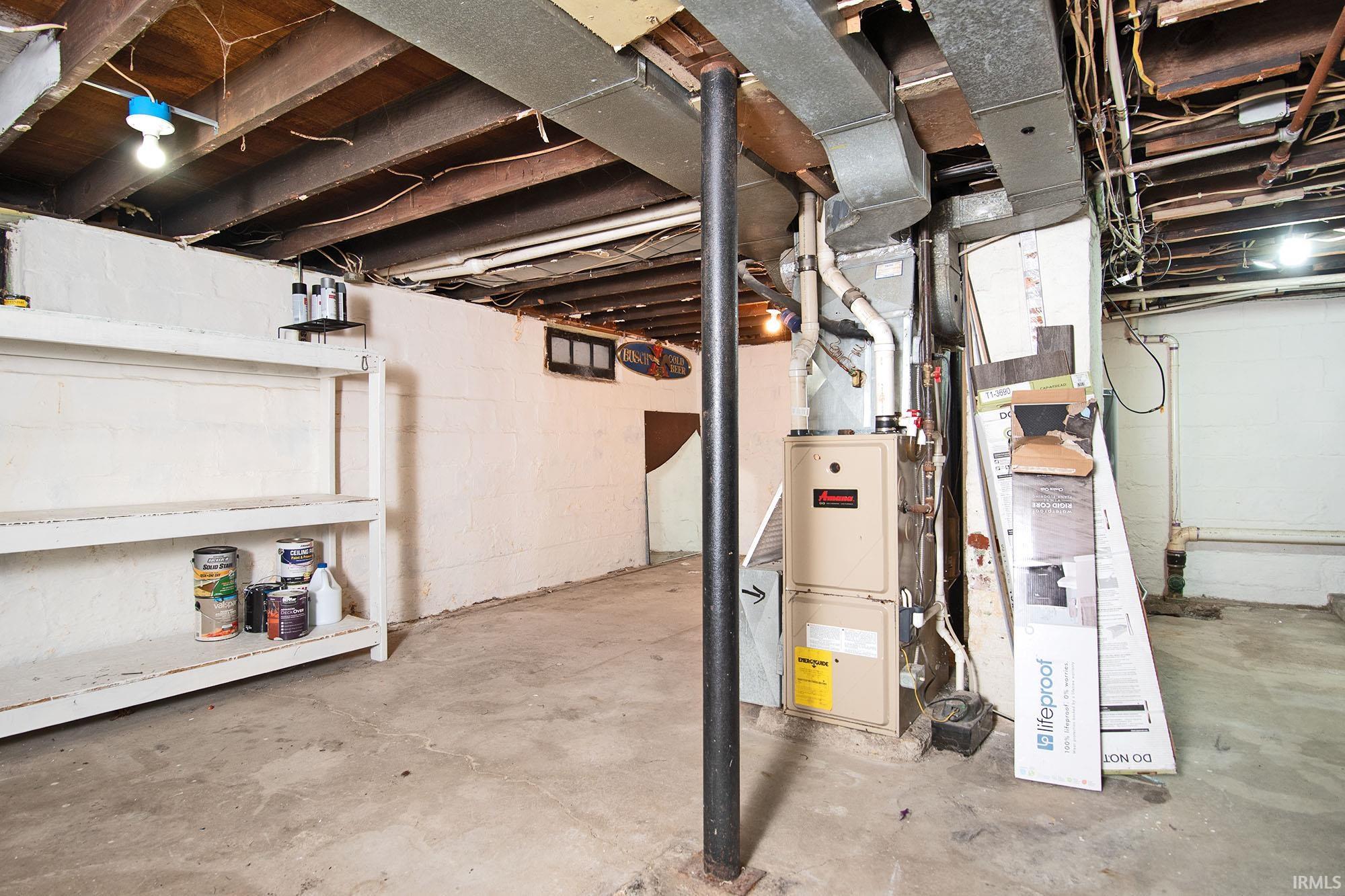 Unfinished basement featuring heating unit