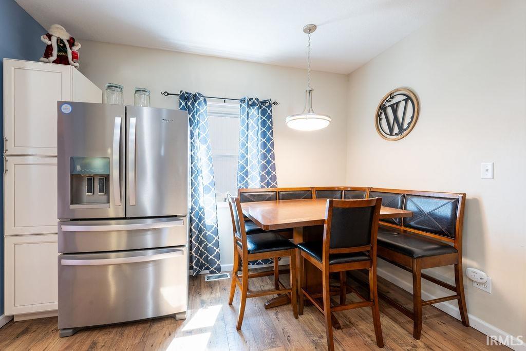 Dining room with light wood-type flooring and baseboards