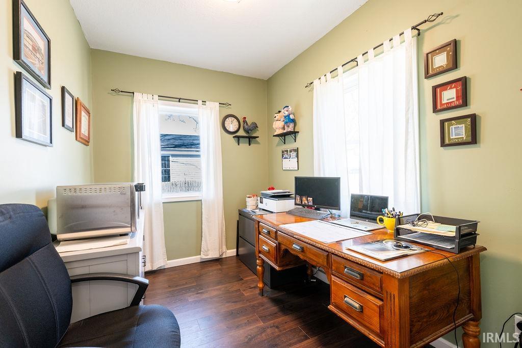 Office space with dark wood finished floors and baseboards
