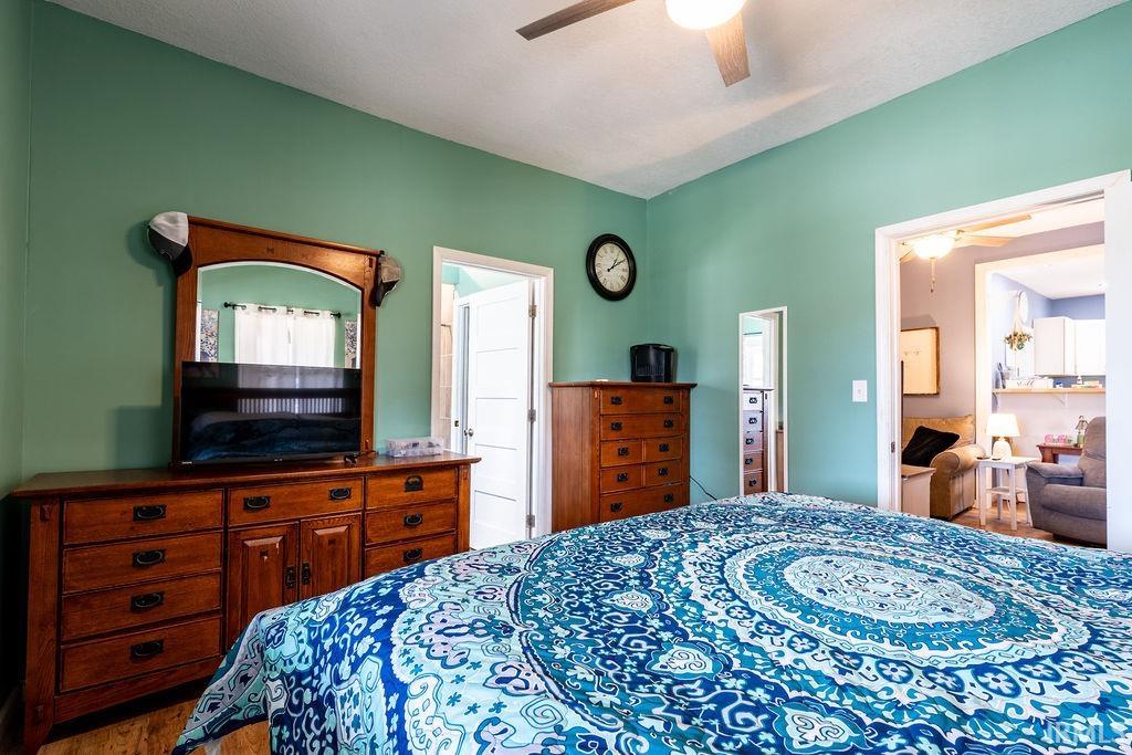 Bedroom with ceiling fan and wood finished floors
