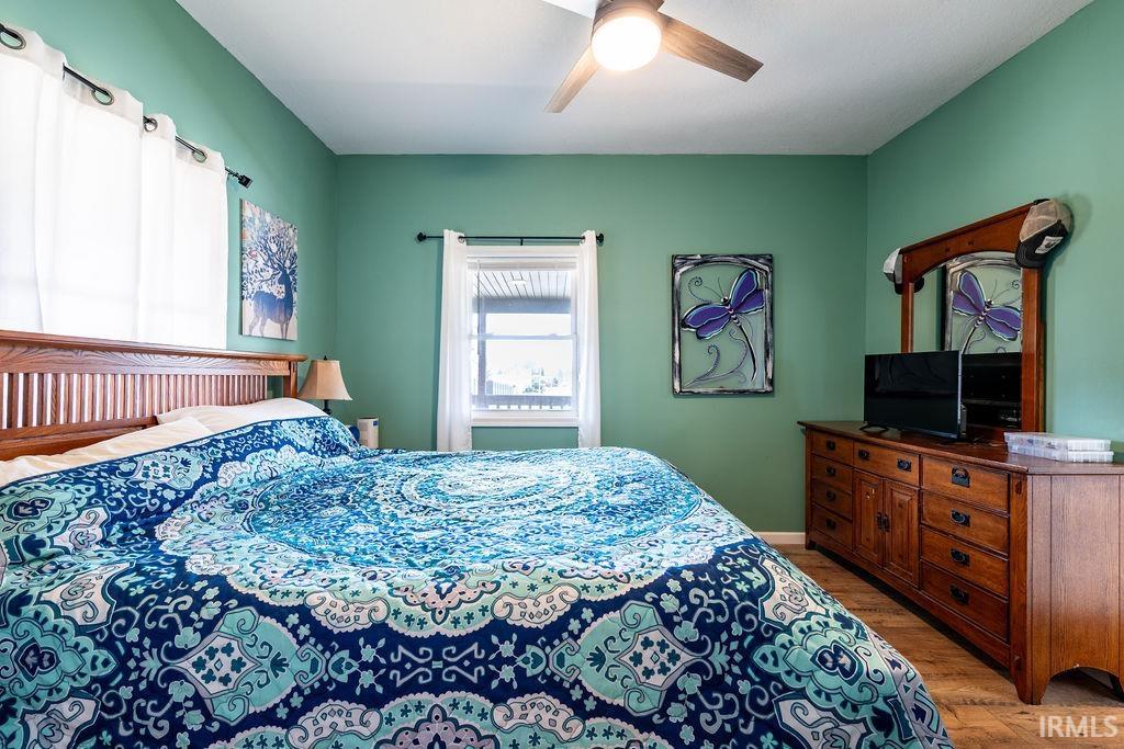 Bedroom with light wood finished floors and ceiling fan
