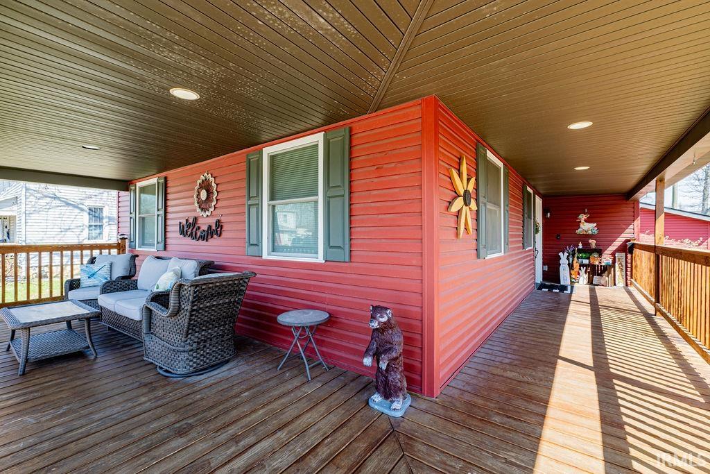 Wooden porch with an outdoor living space