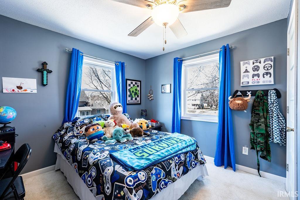 Bedroom featuring light carpet and ceiling fan