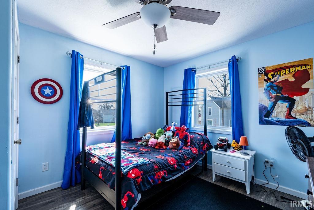 Bedroom featuring a ceiling fan and dark wood finished floors