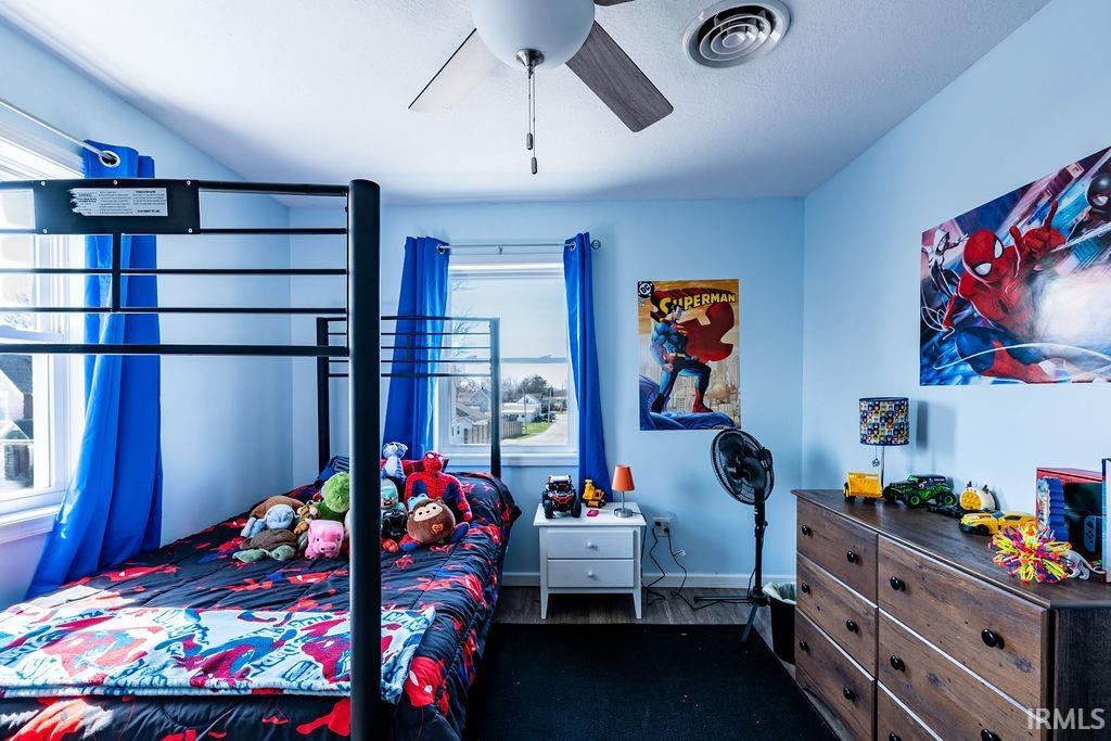 Bedroom featuring dark wood-style floors and a ceiling fan