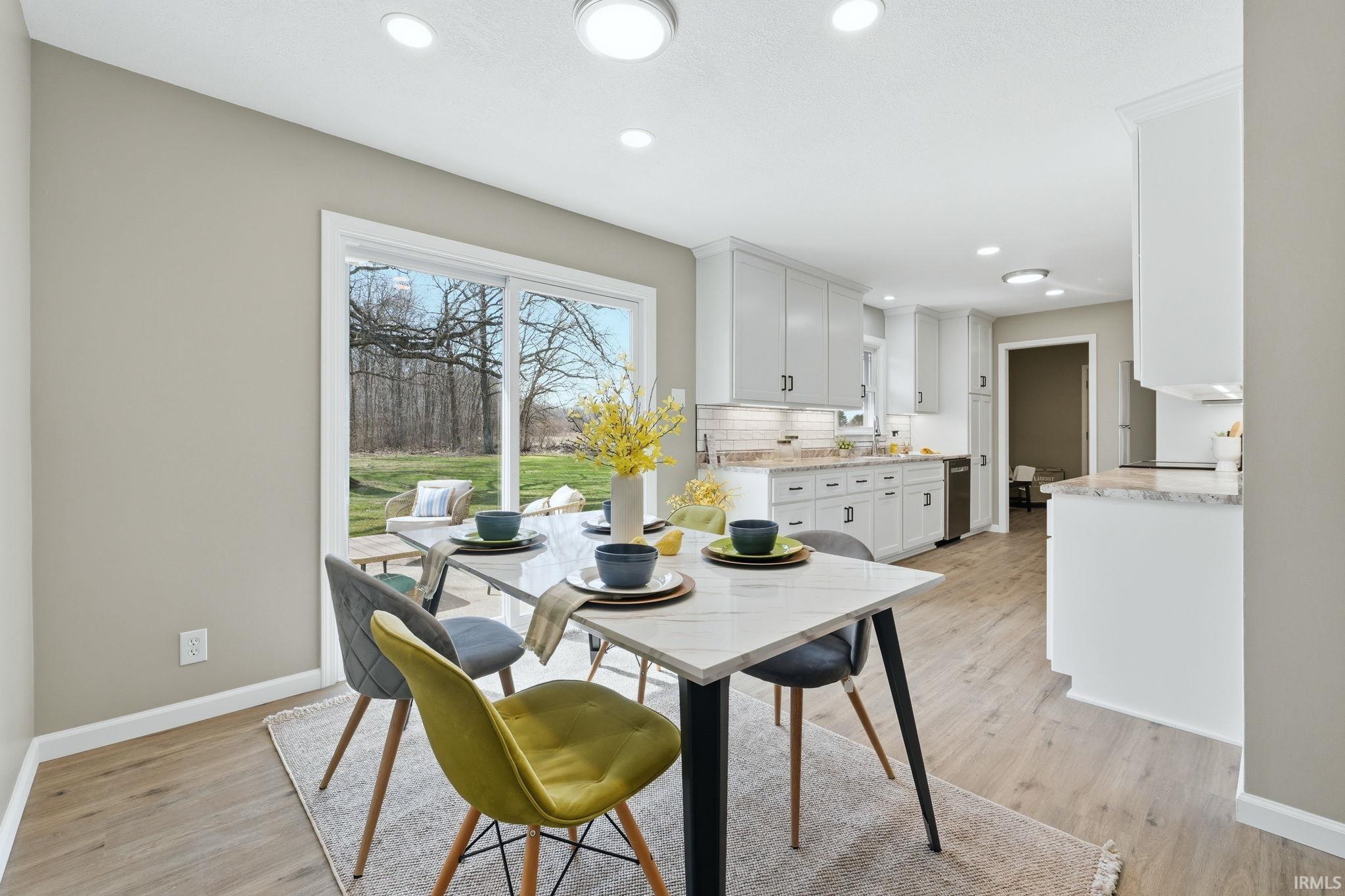 Dining room featuring light wood finished floors and recessed lighting
