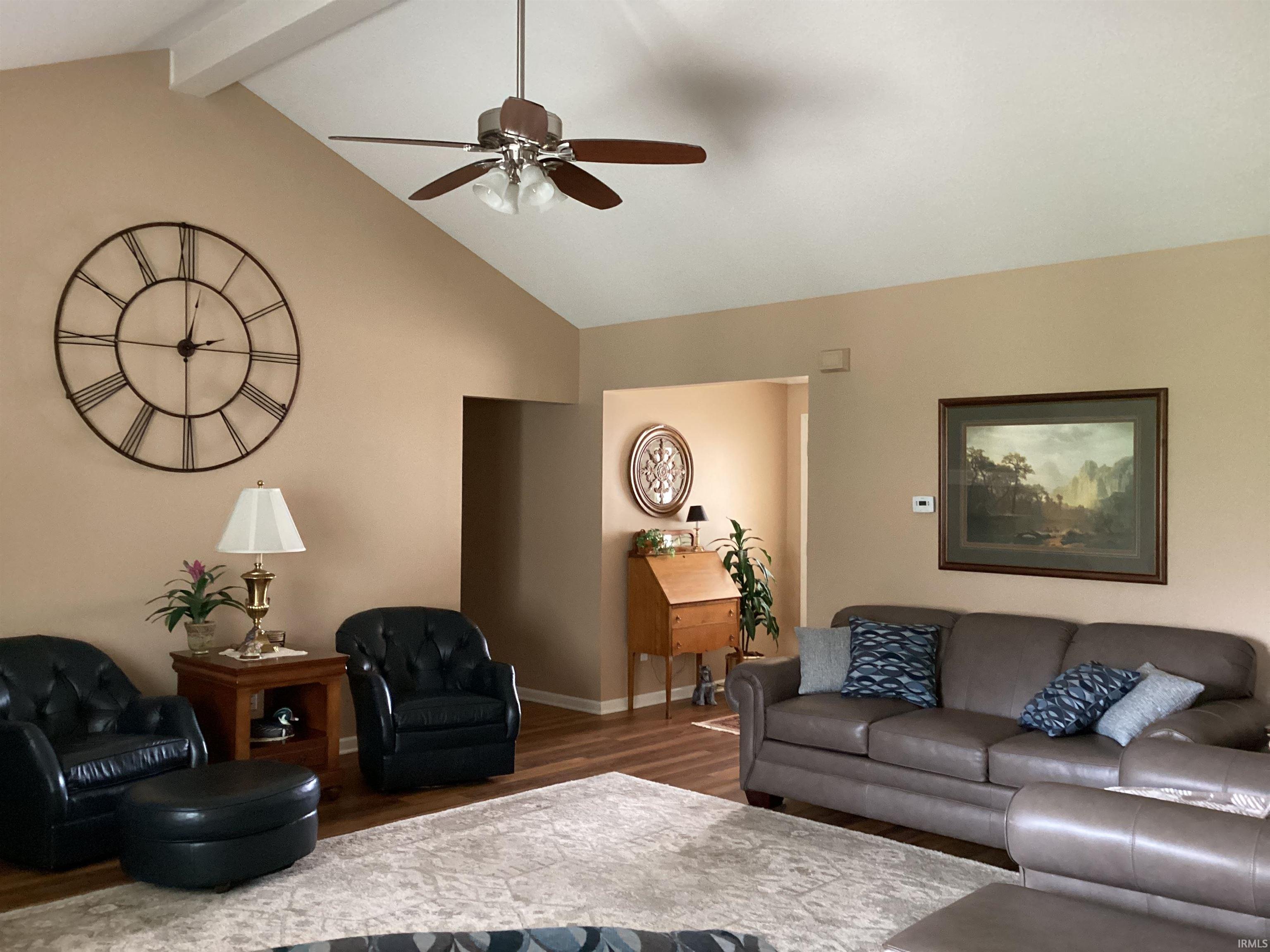 Living room featuring ceiling fan and wood finished floors