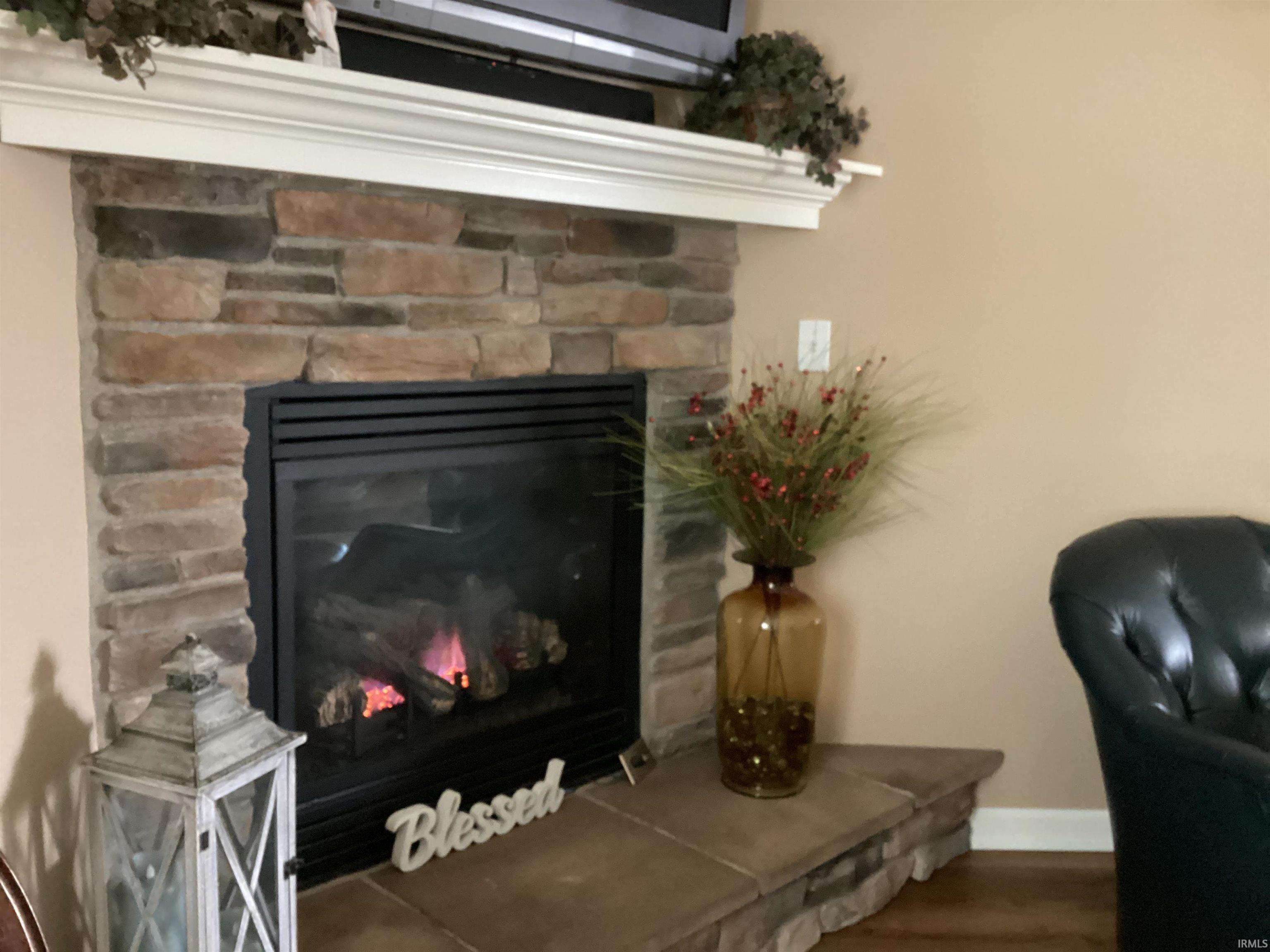 Detailed view of a fireplace and wood finished floors