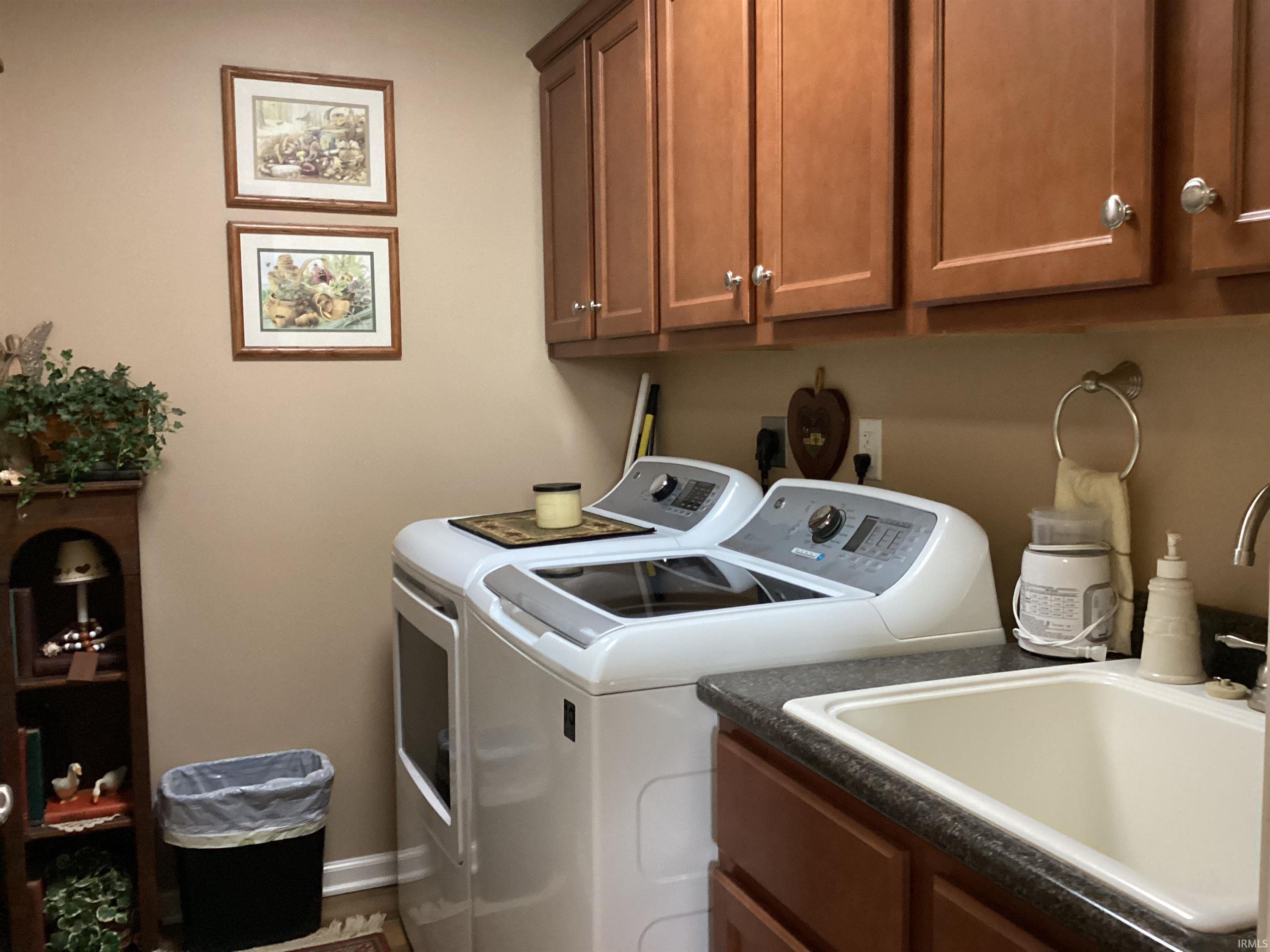 Laundry room with washing machine and clothes dryer and cabinet space