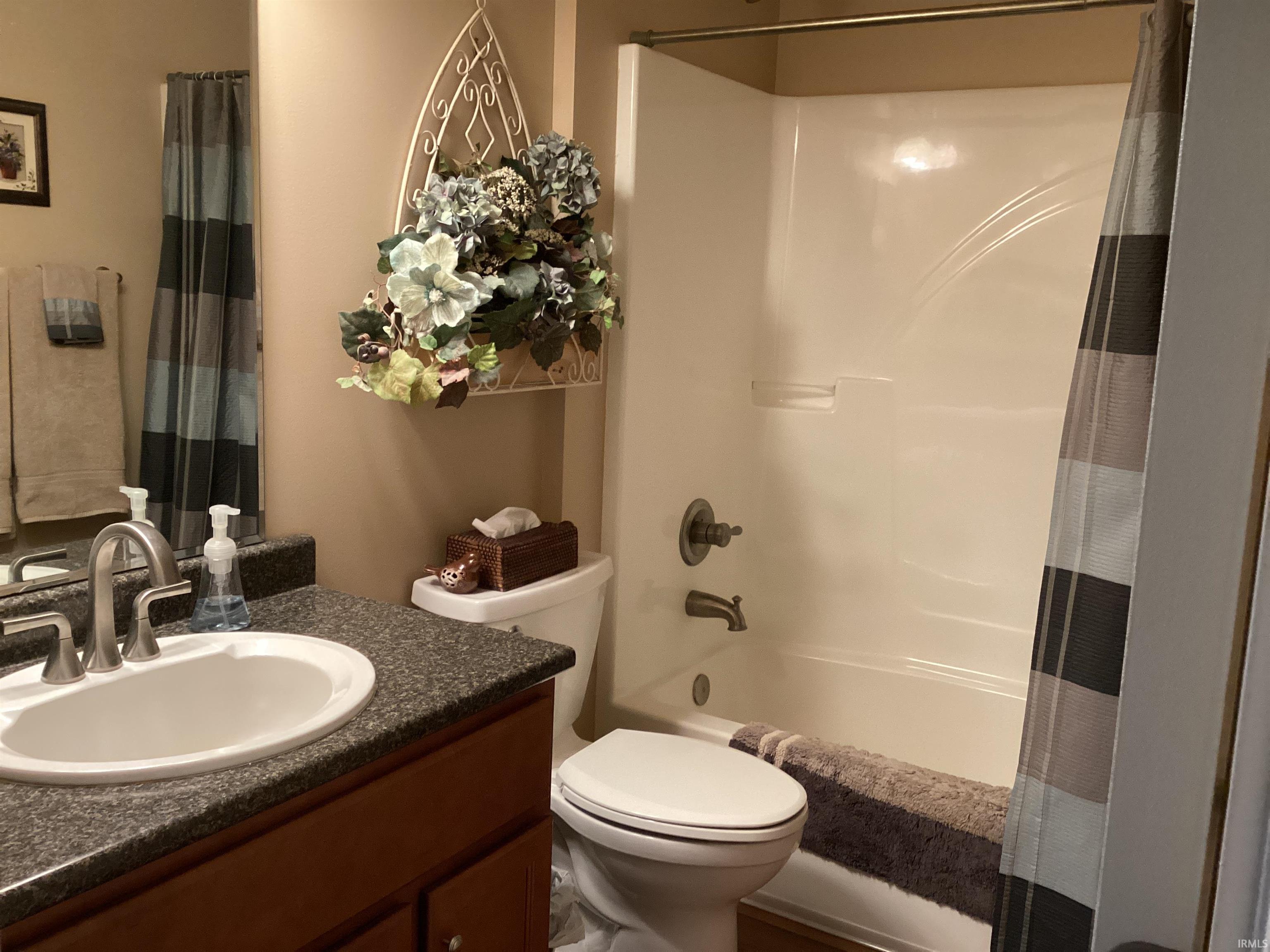 Bathroom featuring vanity and shower / bath combo with shower curtain