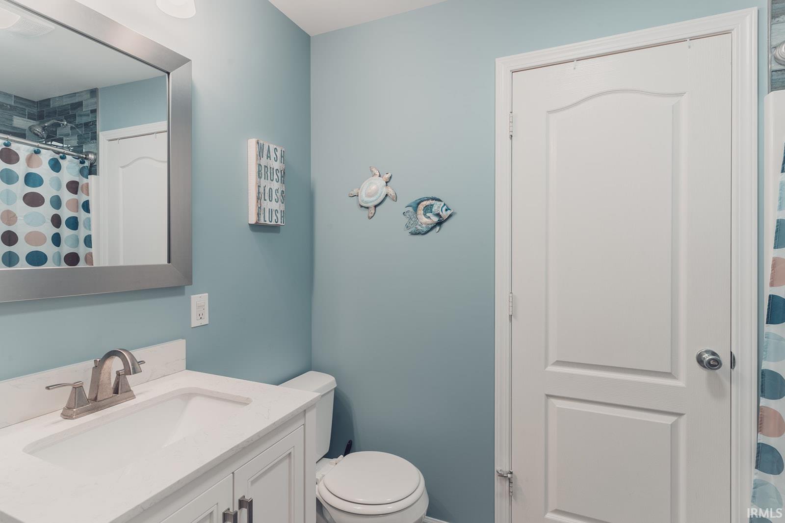Bathroom with vanity and curtained shower