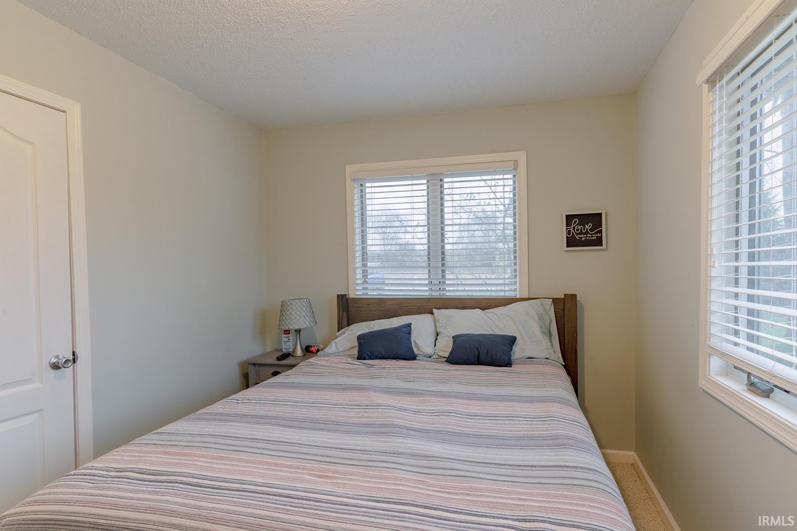 Bedroom featuring a textured ceiling and carpet flooring