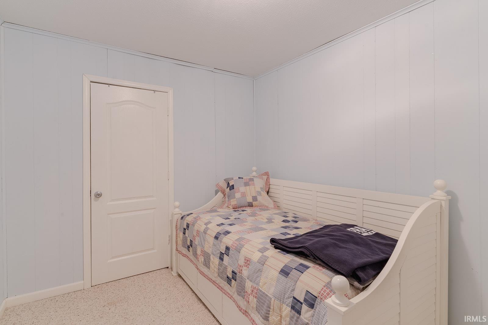 Bedroom featuring wooden walls