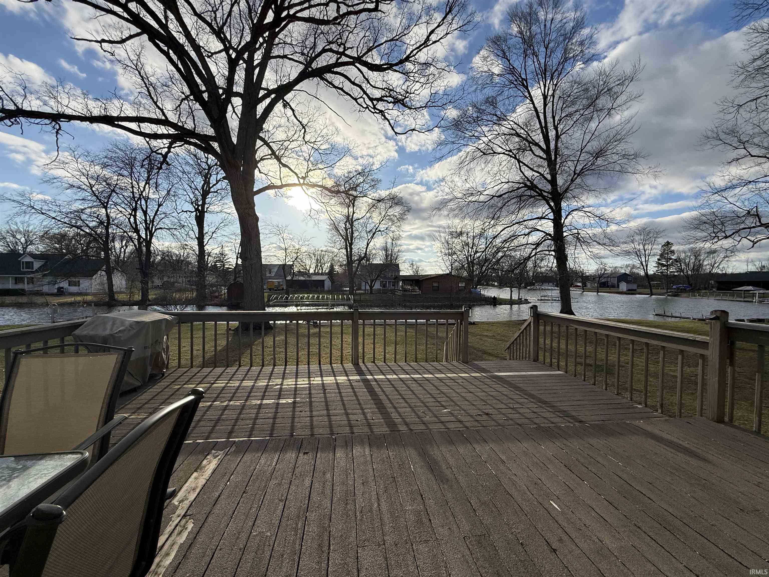 Deck featuring a water view and a lawn